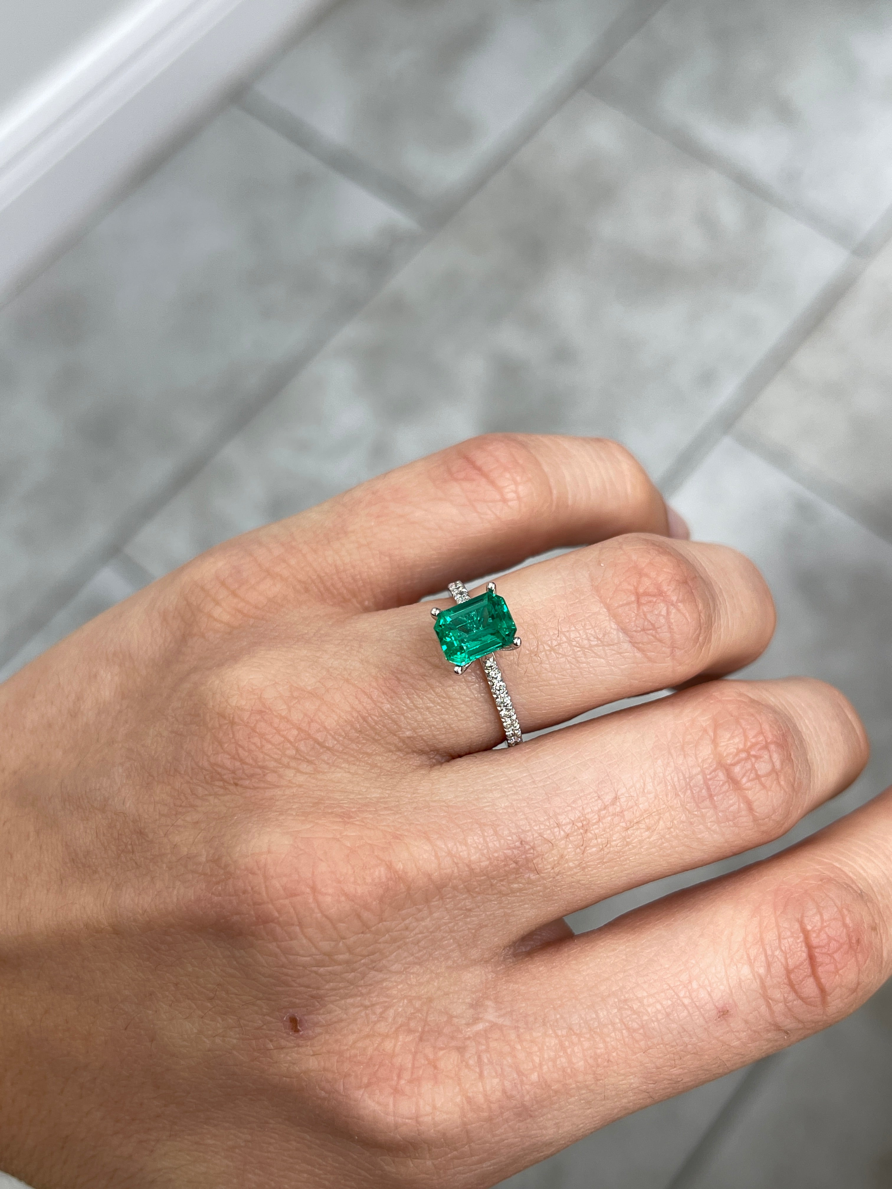 Vivid bluish green 1.49 carat Colombian emerald cut gemstone from JR Colombian Emeralds, showcasing a classic rectangular shape and high clarity.