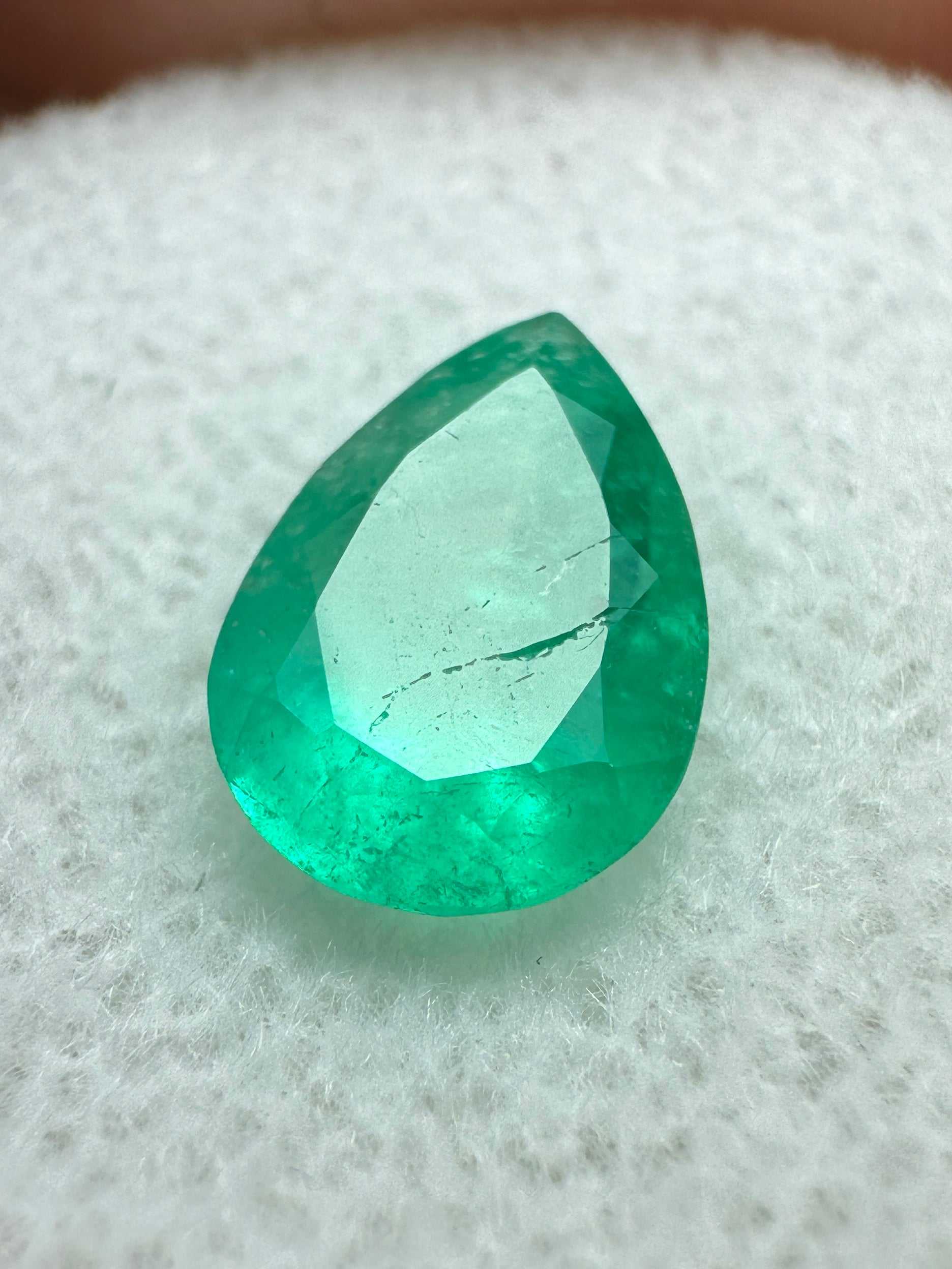 1.58 carat medium green natural Colombian emerald loose gemstone in pear cut with vibrant color and clarity.