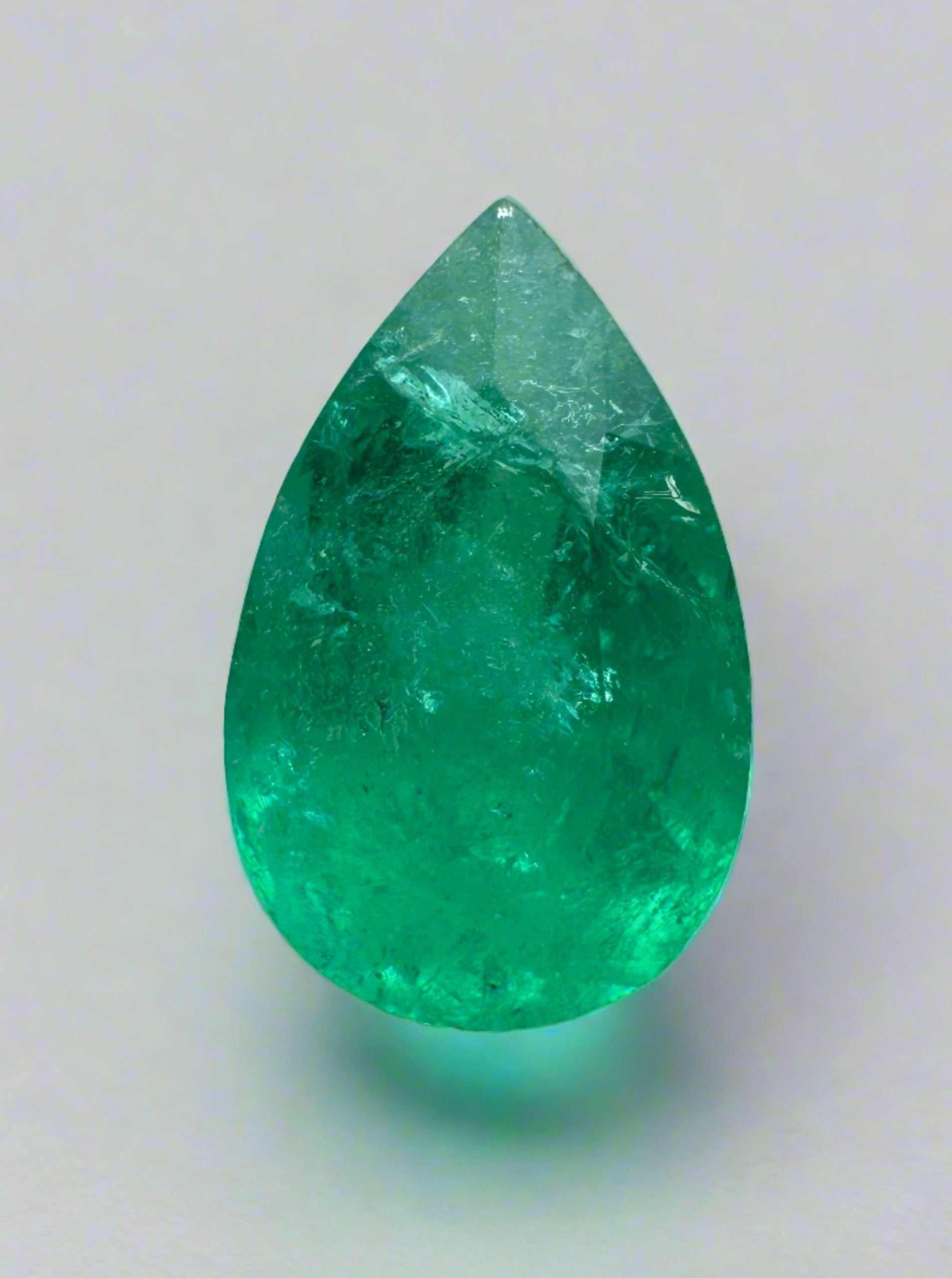 1.62 carat rich green natural Colombian emerald loose gemstone in pear cut, showcasing vibrant color and clarity.