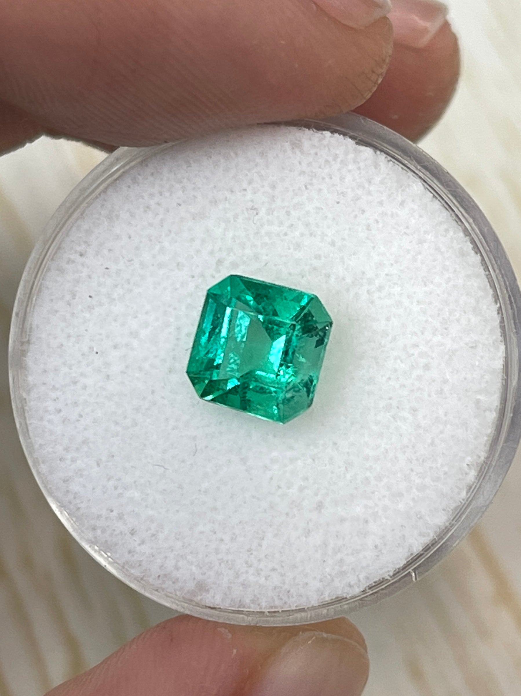1.64 carat yellowish green Asscher cut Colombian emerald by JR Colombian Emeralds with natural unset gemstone.