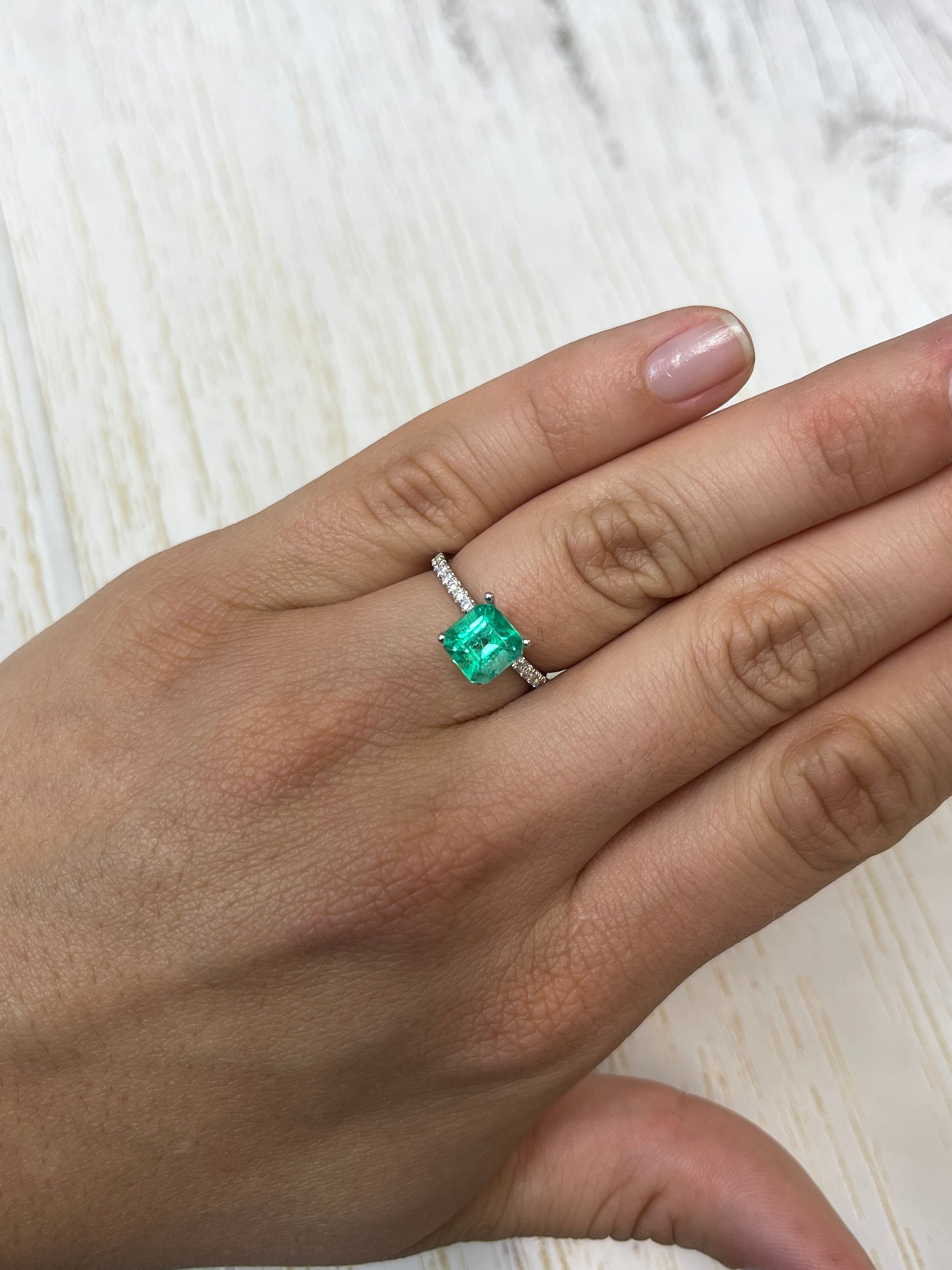 1.64 carat yellowish green Asscher cut Colombian emerald from JR Colombian Emeralds, natural and unset, with precise dimensions.