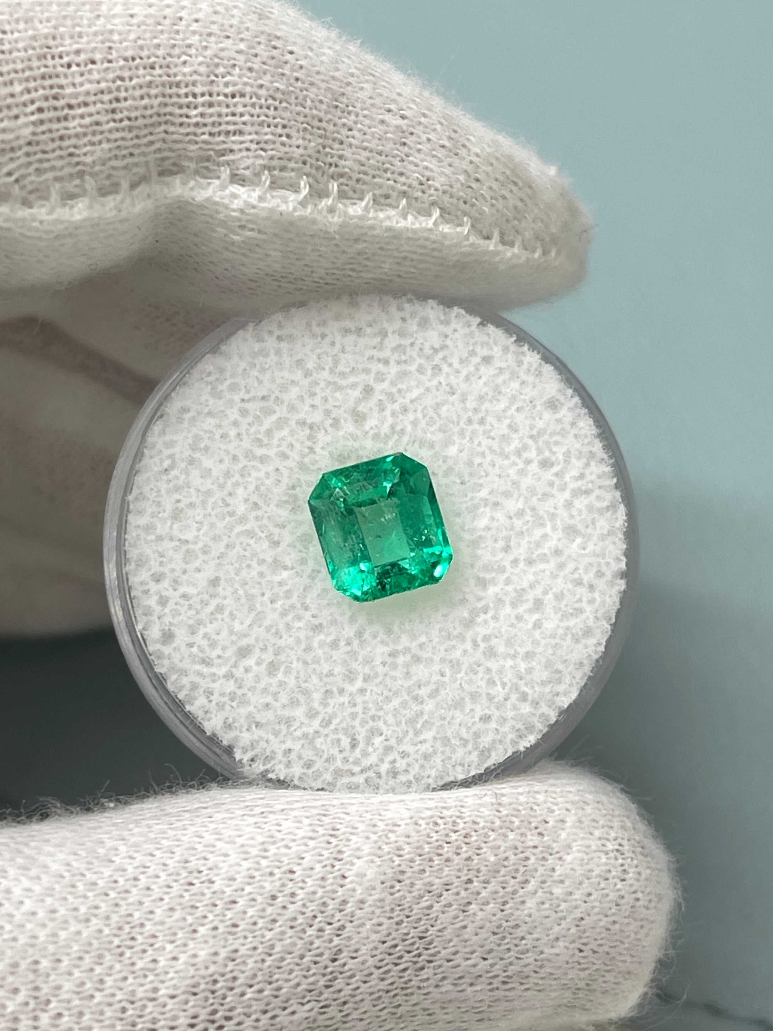 7.5x7 Crystalline Muzo yellowish green Asscher cut natural Colombian emerald, 1.68 carat, displayed on a neutral background.