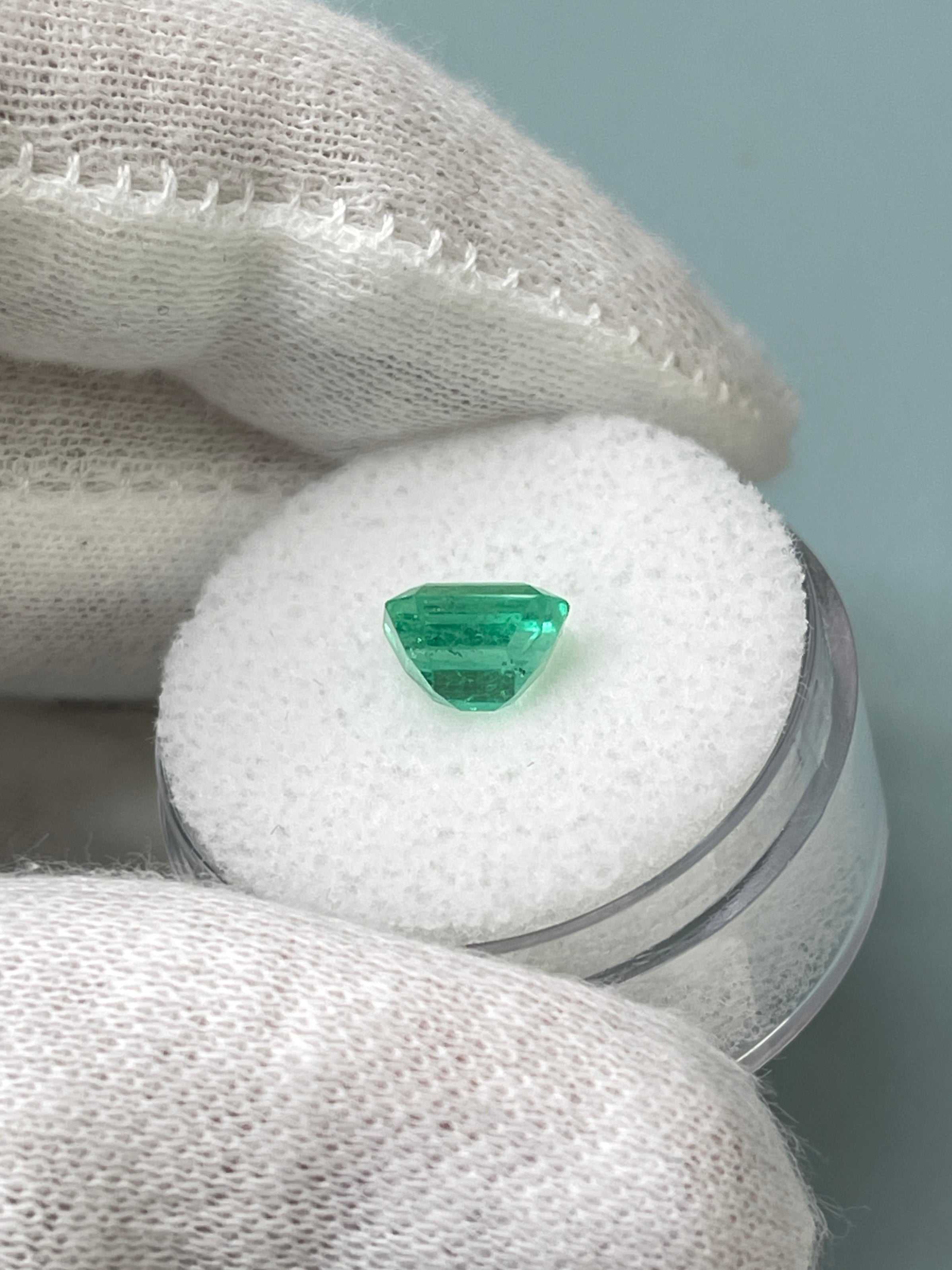 1.68 carat yellowish green Asscher cut Colombian emerald with crystalline clarity, showcasing its brilliant facets.