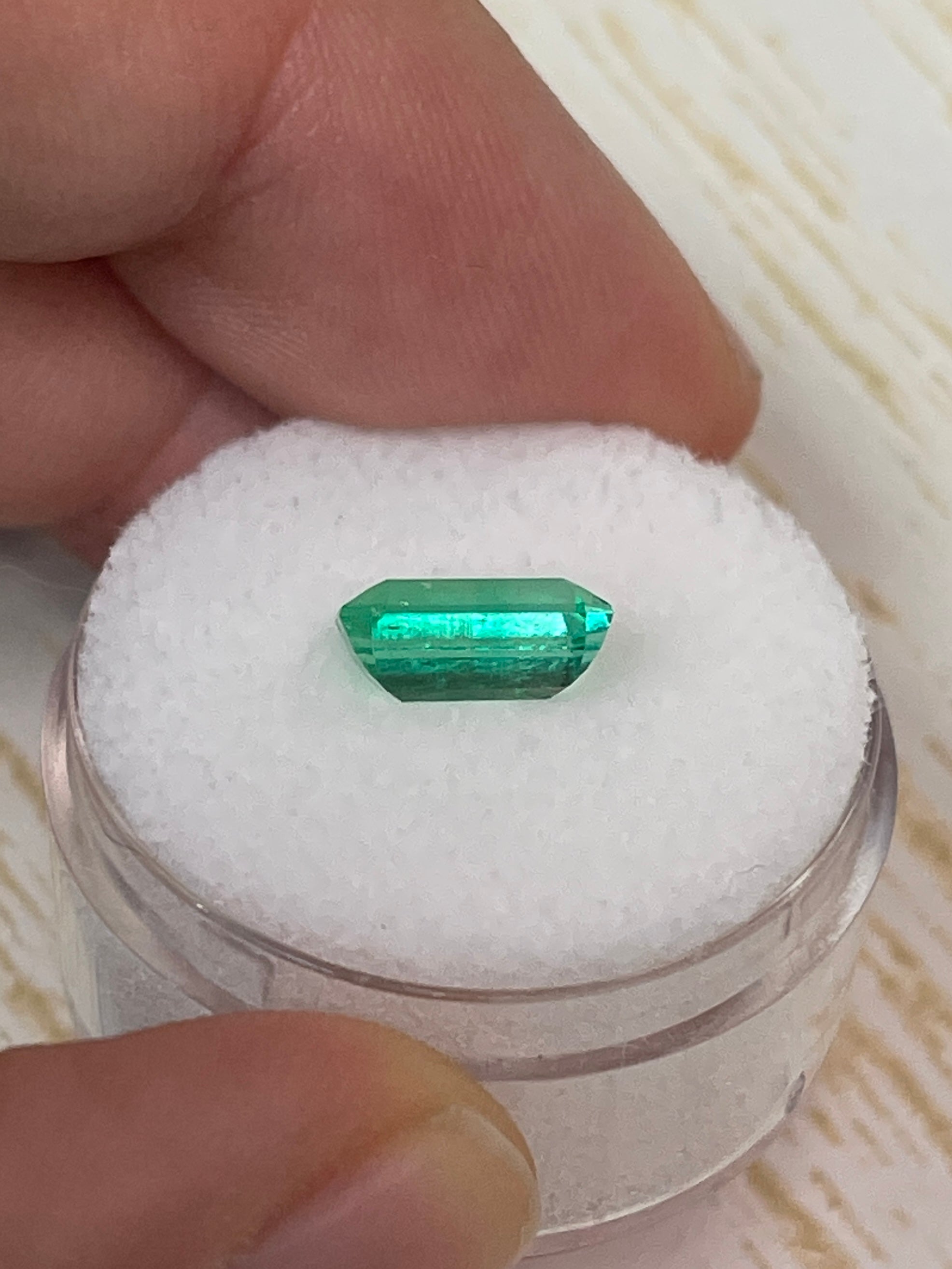 Natural 1.68 carat yellowish green Colombian emerald in emerald cut, loose gemstone with vivid color and clarity.