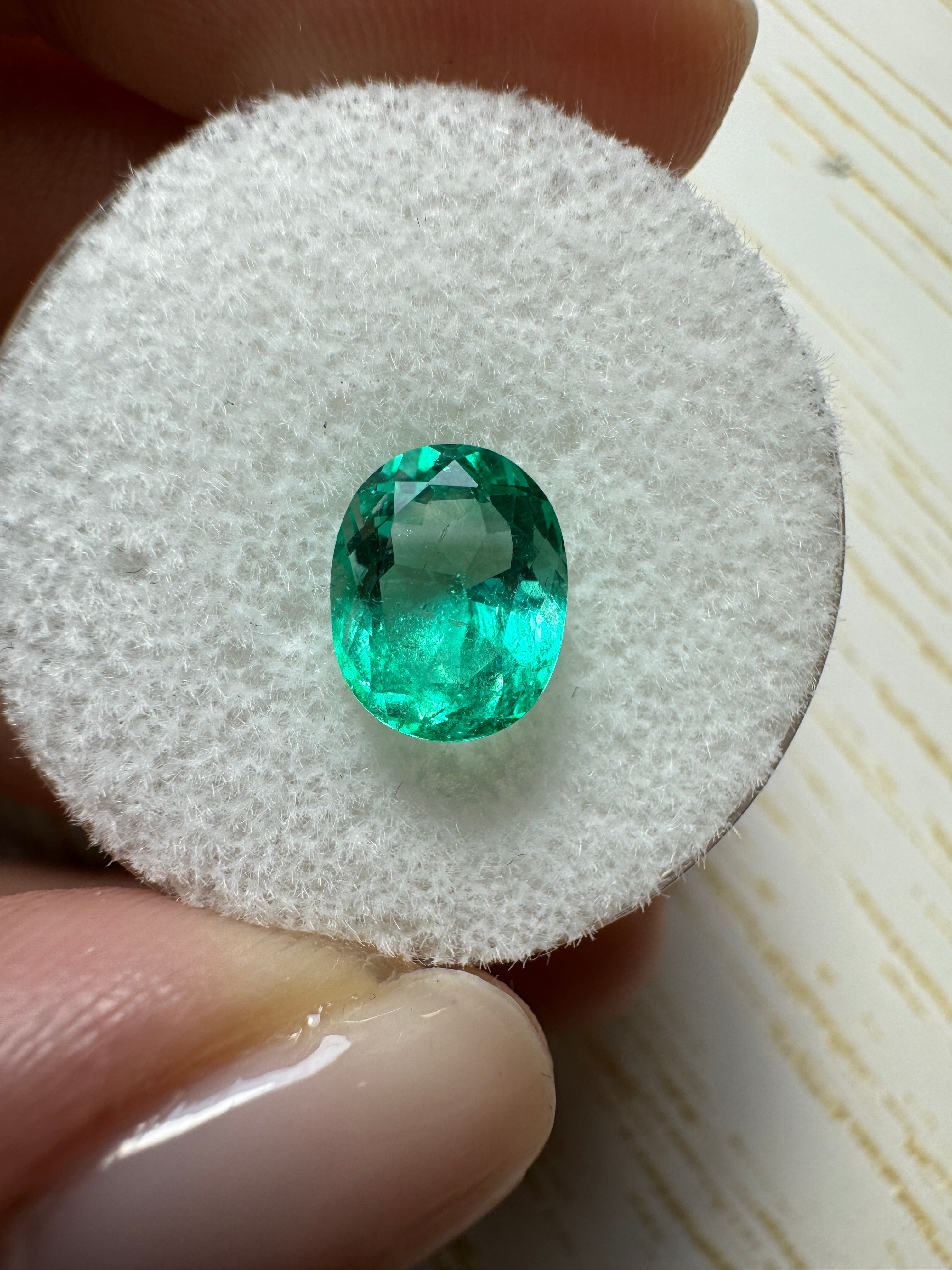 Oval cut 1.72 carat spring green Colombian emerald loose gemstone with crystalline clarity, from JR Colombian Emeralds.