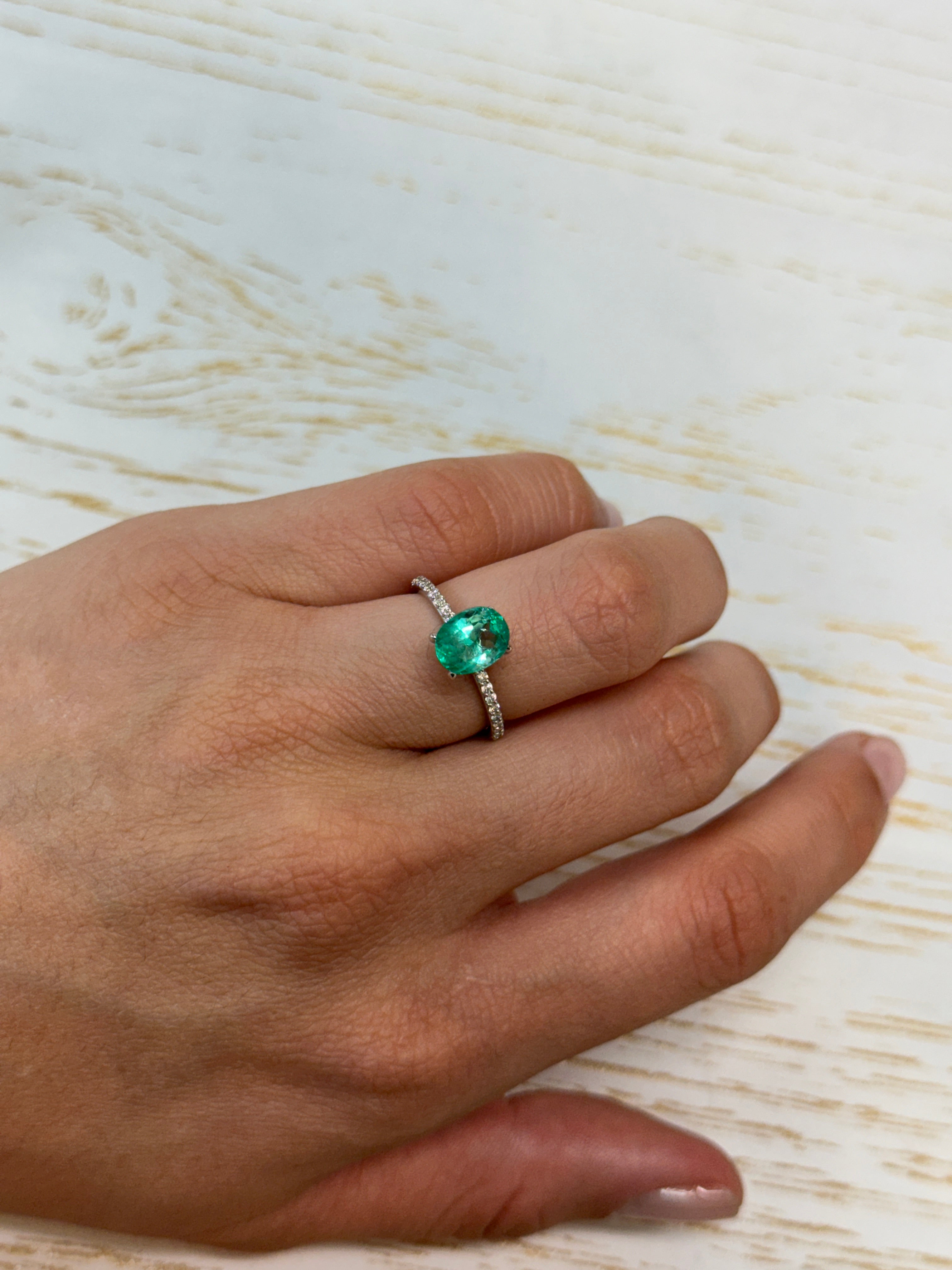 Oval cut 1.72 carat spring green Colombian emerald loose gemstone from JR Colombian Emeralds, showcasing crystalline clarity.