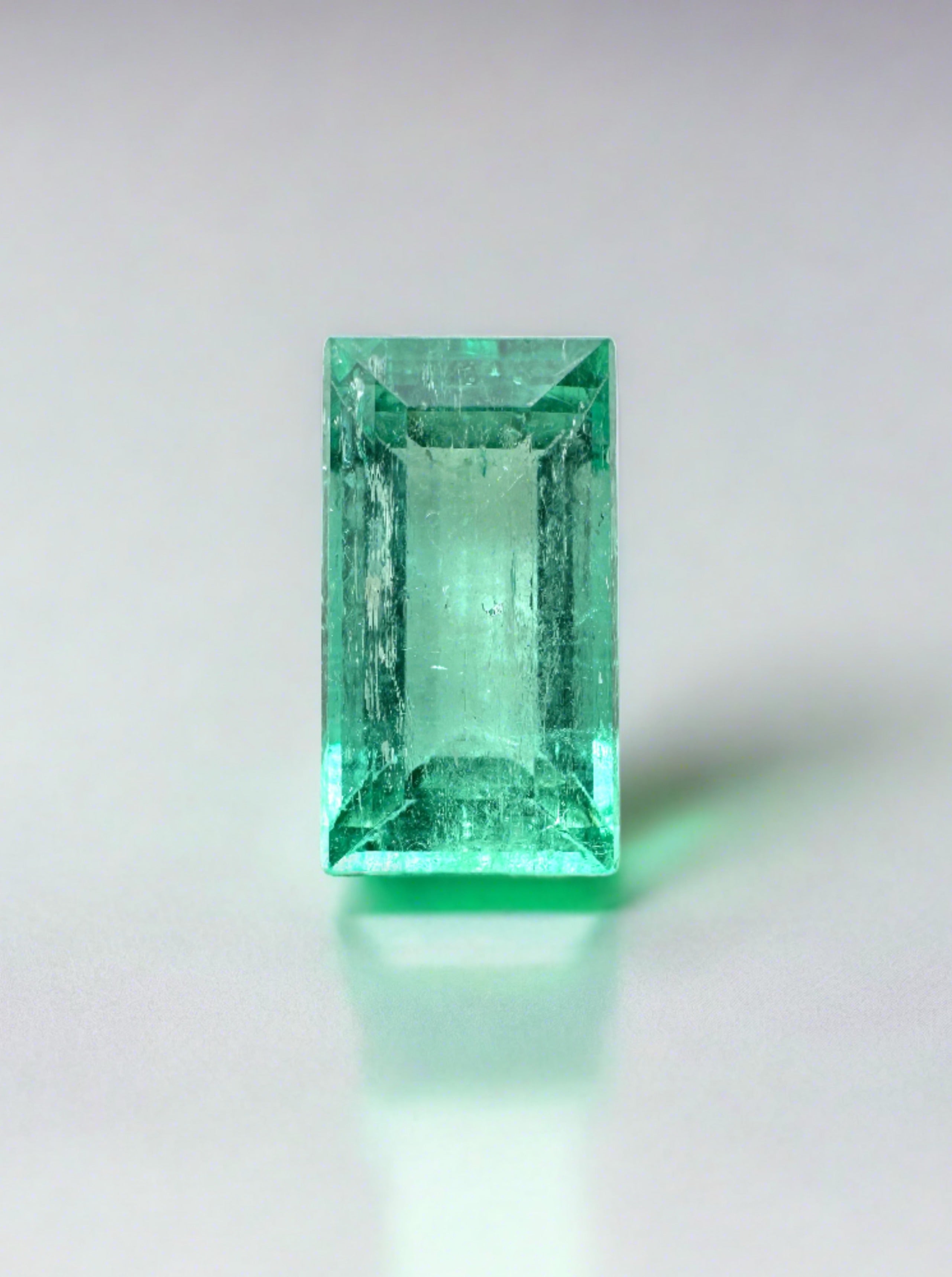 Loose 1.72 carat vivacious Colombian emerald baguette with vibrant green color and natural clarity, from JR Colombian Emeralds.