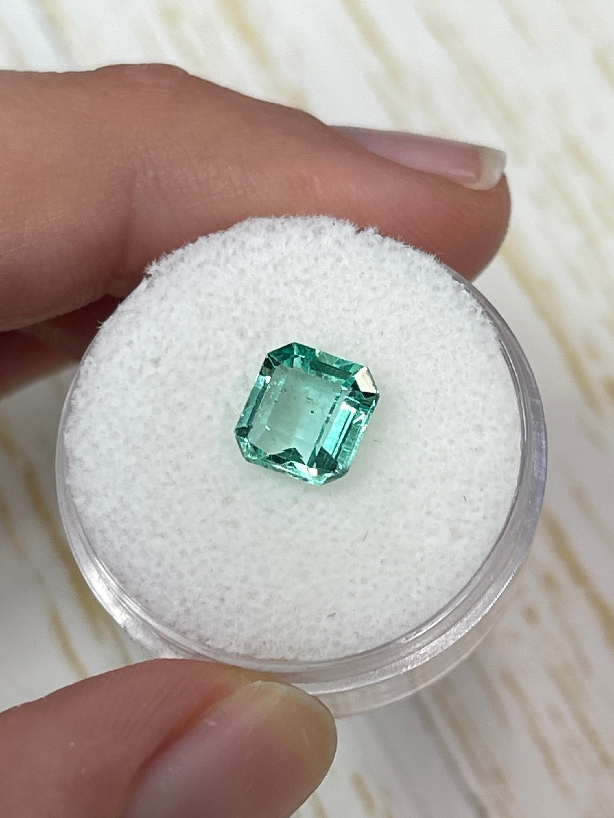 1.74 carat freckled Colombian emerald loose Asscher cut gemstone from JR Colombian Emeralds, showcasing deep green color and unique inclusions.