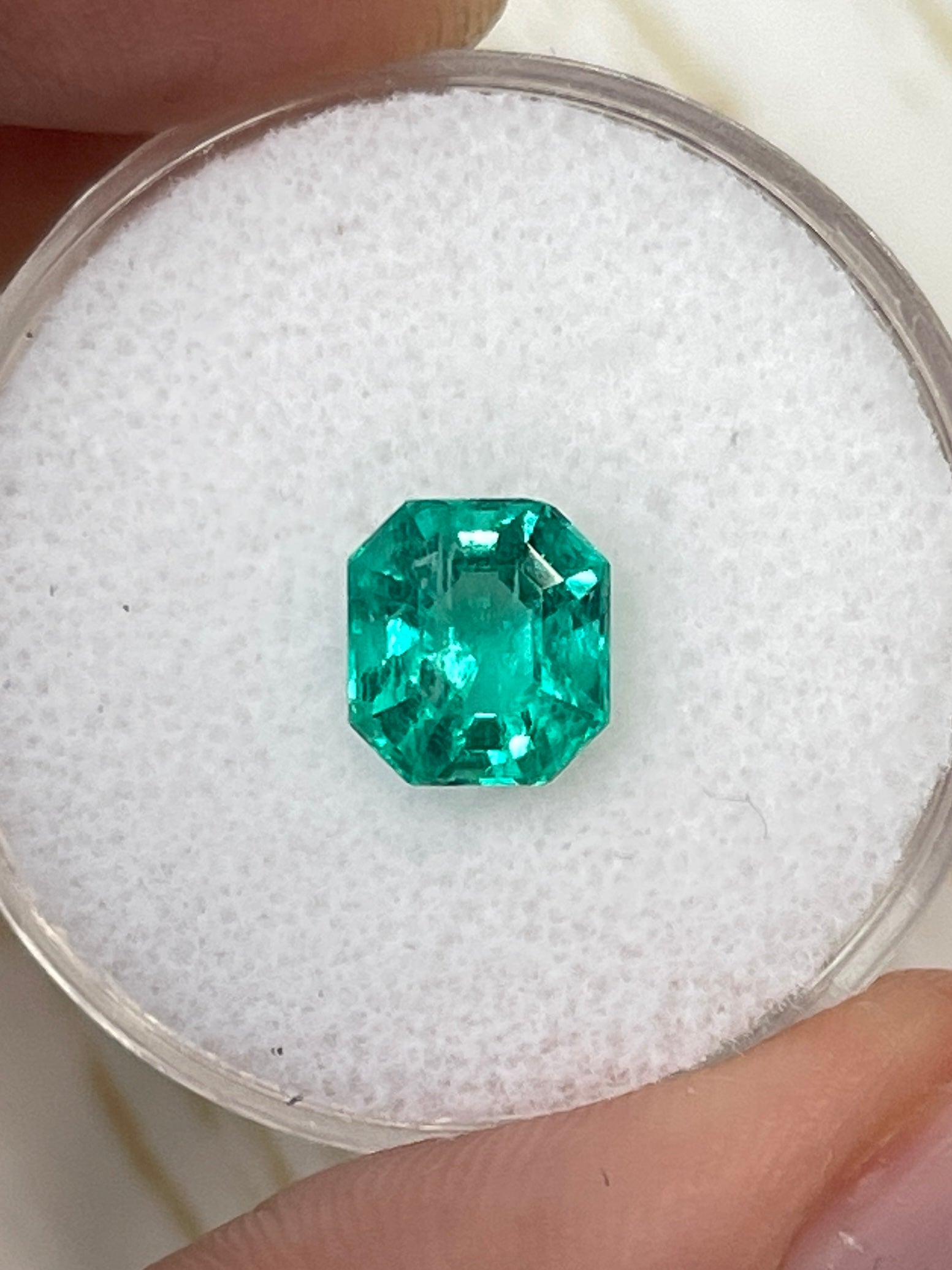 1.79 carat green Colombian emerald gemstone with 7.5x7 mm Asscher cut, natural and uncut, showcased by JR Colombian Emeralds.