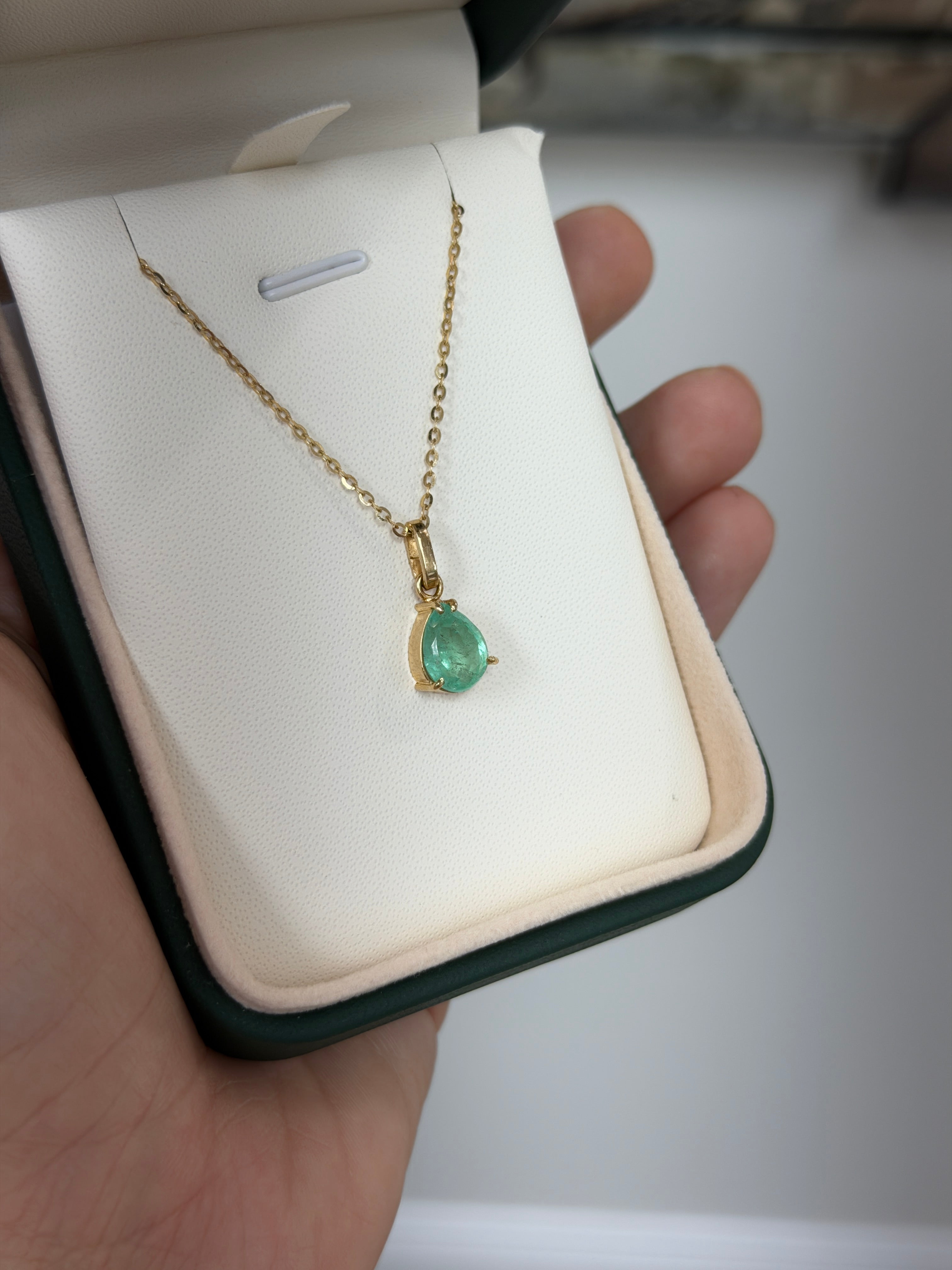 Light green Colombian emerald pear cut solitaire necklace with 1.80 carats, showcasing elegant jewelry from JR Colombian Emeralds.