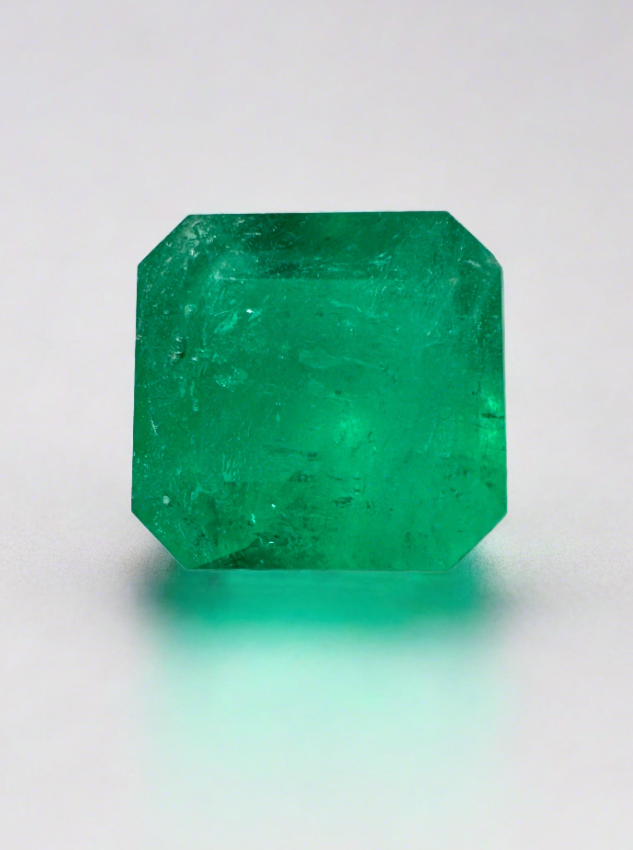 Natural 1.84 carat Colombian emerald loose gemstone in an 8x8mm Asscher cut, showcasing vibrant green color and clarity.