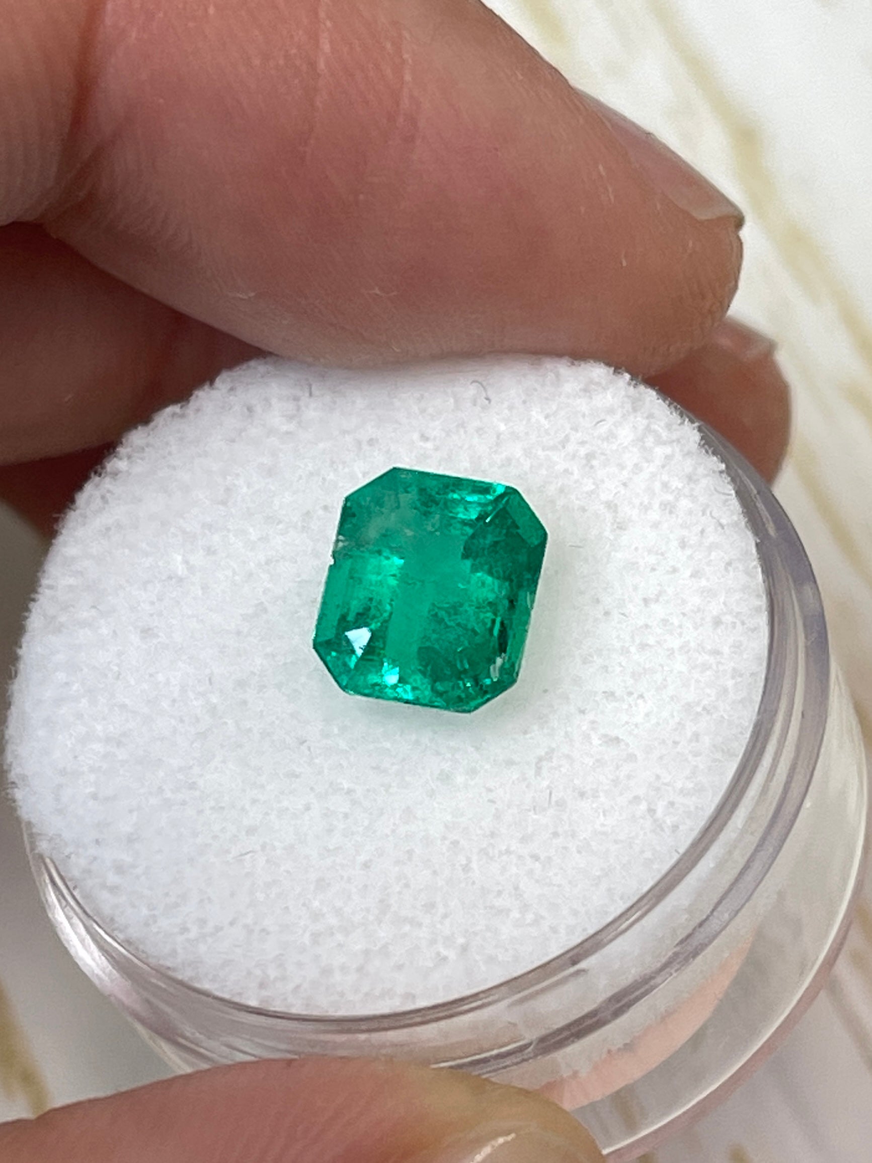 Freckled green 1.94 carat natural Colombian emerald in emerald cut, loose gemstone from JR Colombian Emeralds.