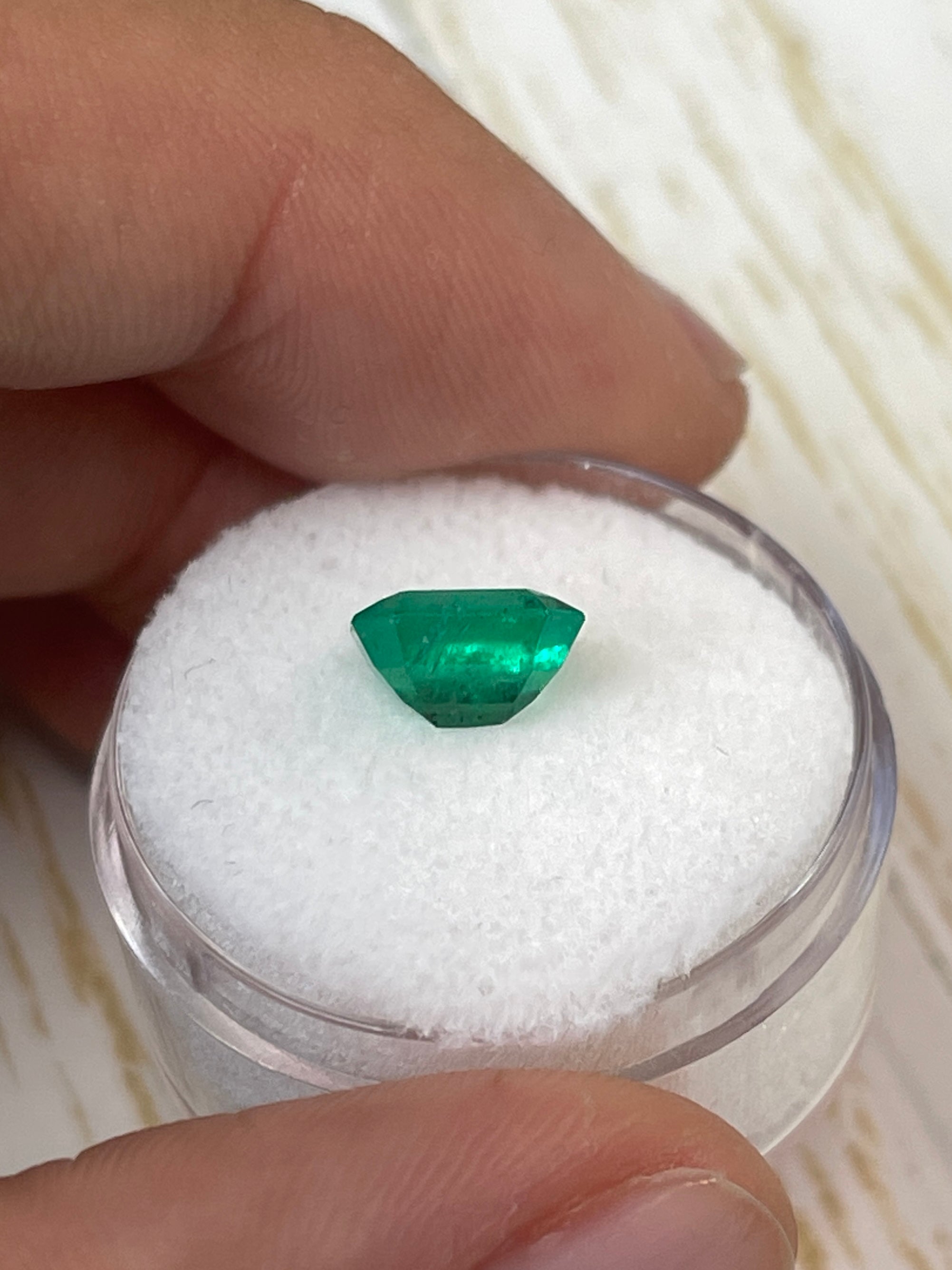 Natural 1.94 carat green Colombian emerald loose gemstone in emerald cut with natural freckles, from JR Colombian Emeralds.