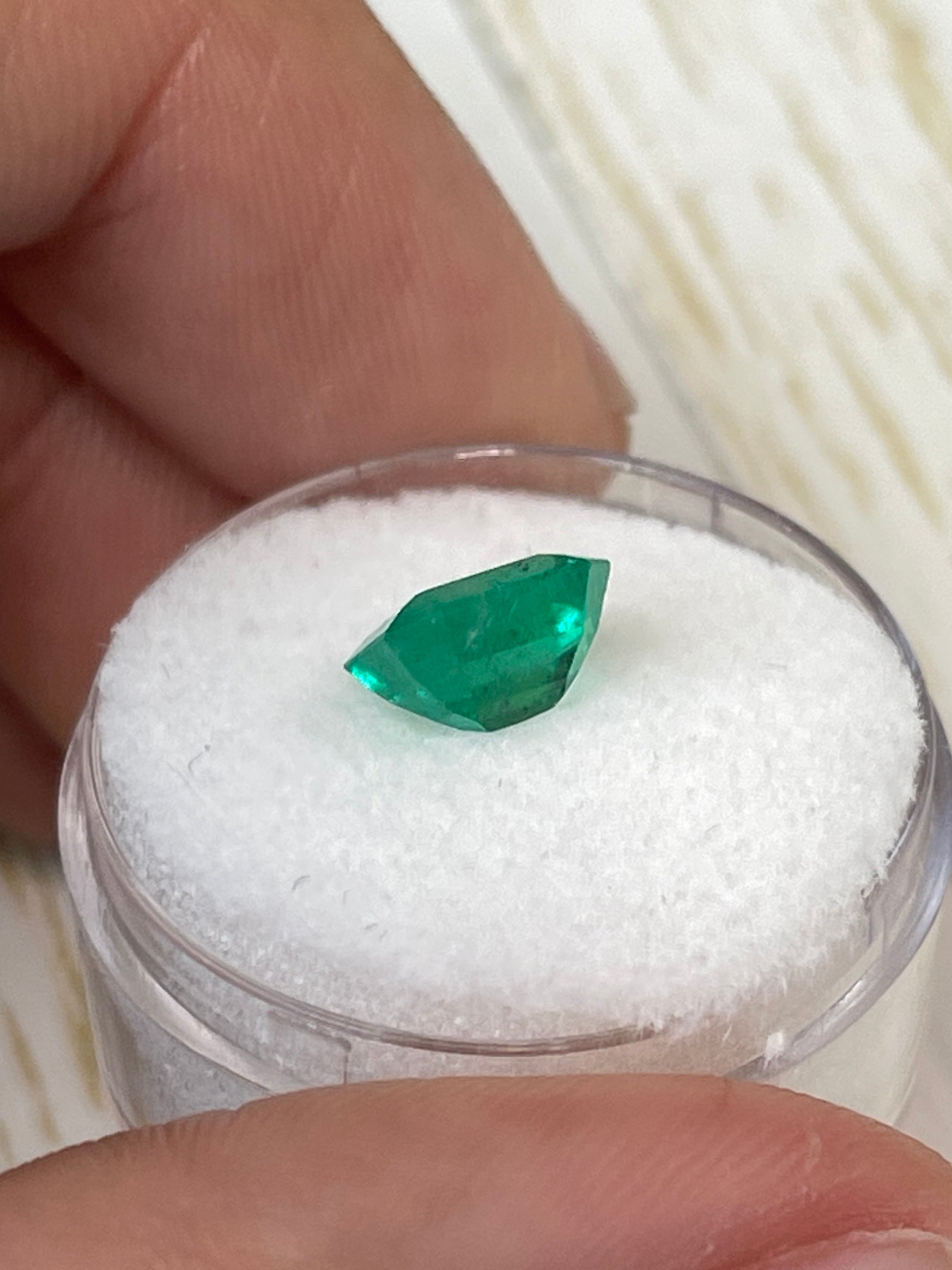 1.94 carat natural loose Colombian emerald, emerald cut, with freckled green color, from JR Colombian Emeralds.