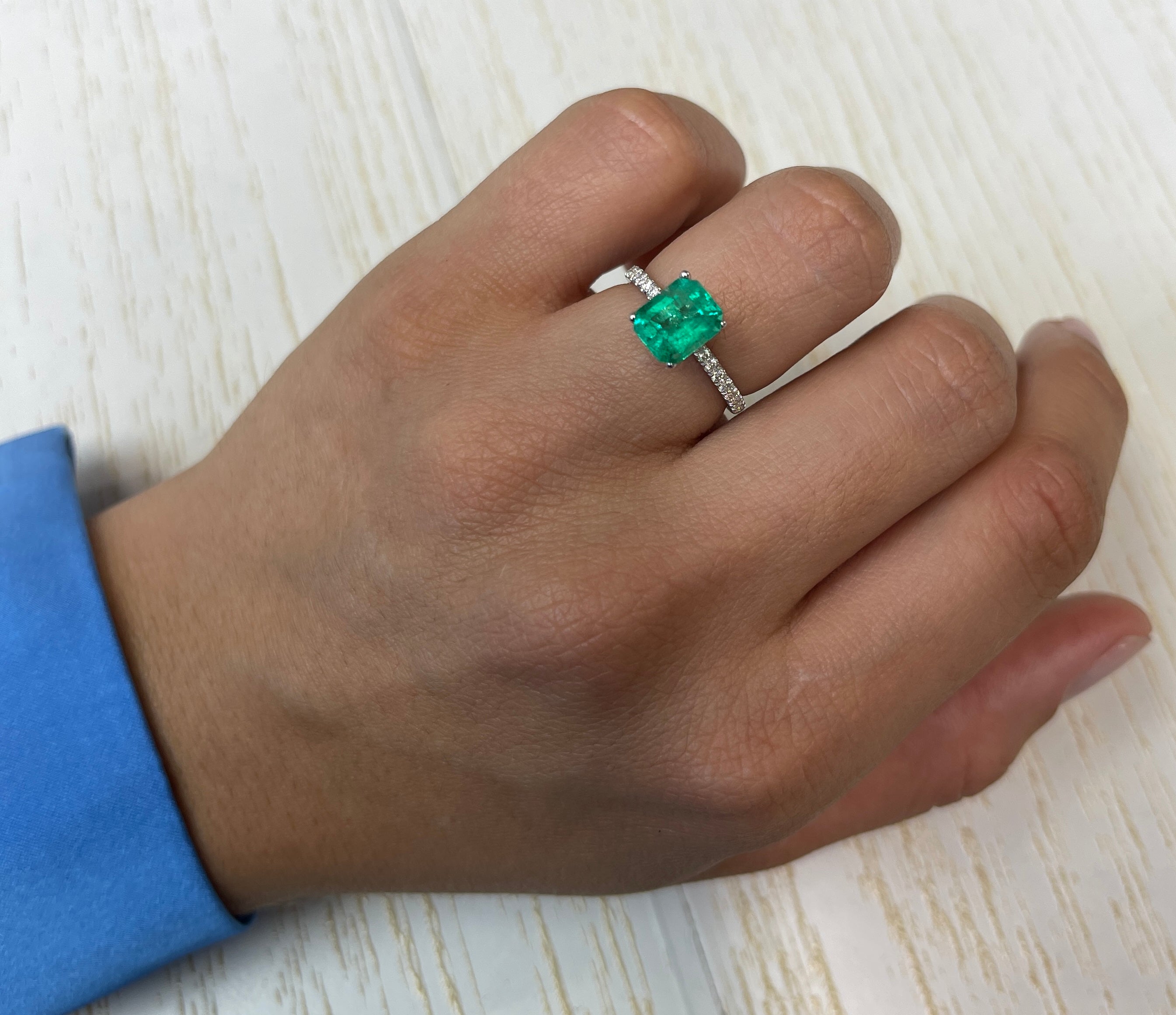 1.94 carat green Colombian emerald loose gemstone with emerald cut, natural freckled appearance, from JR Colombian Emeralds.