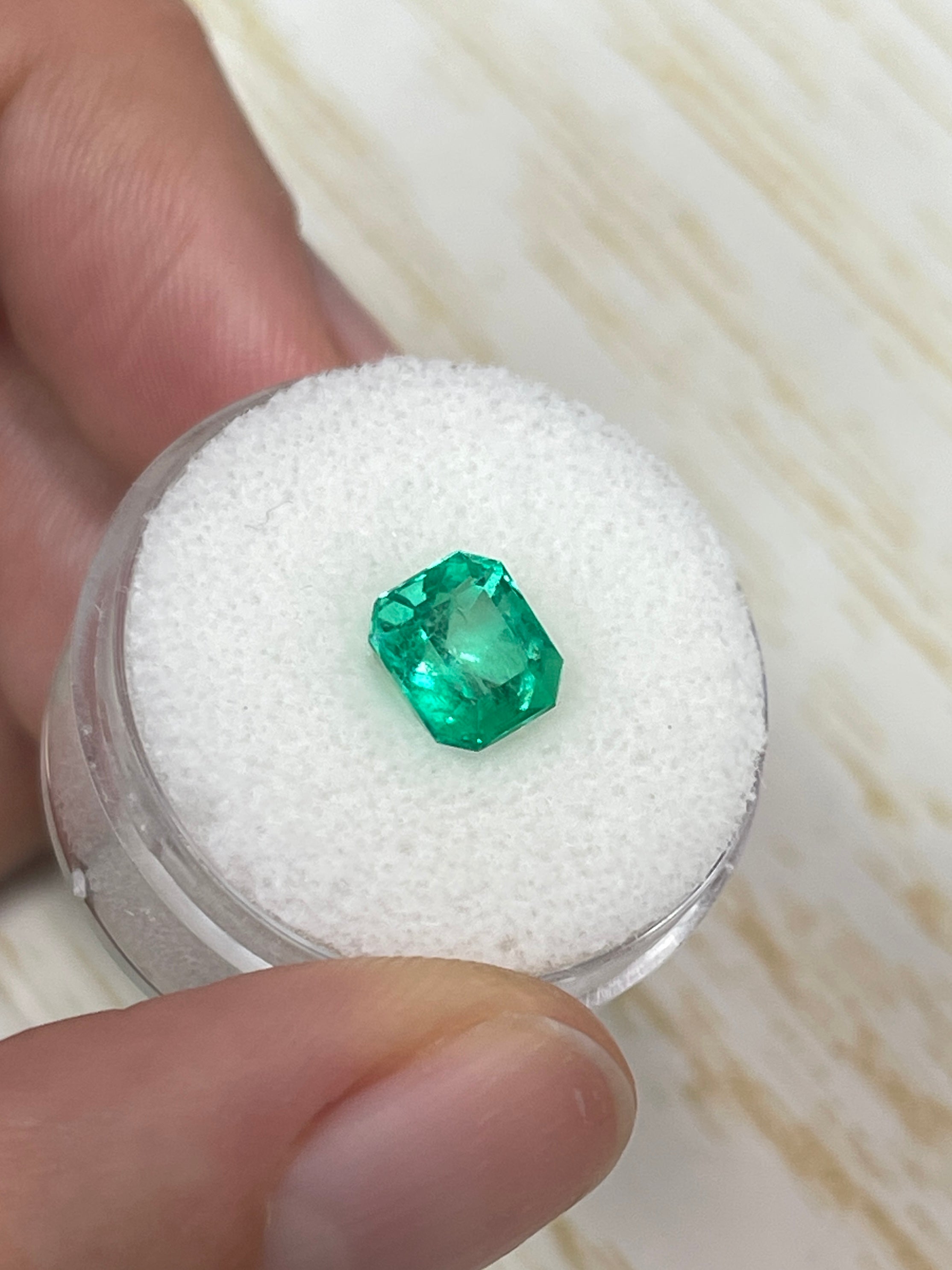 Vivid glowing green 1.96 carat natural Colombian emerald loose gemstone in emerald cut, from JR Colombian Emeralds.