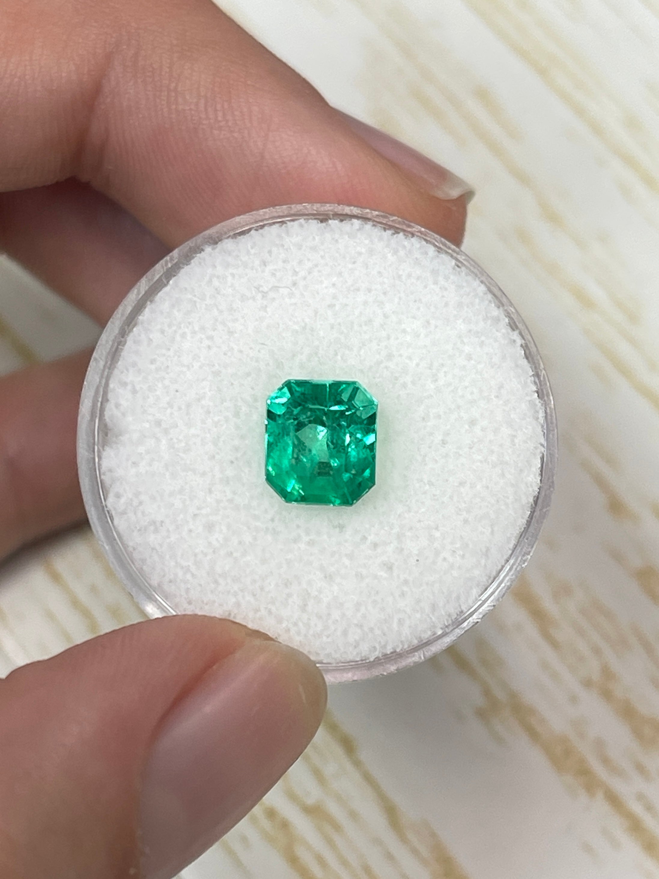Vivid glowing green 1.96 carat natural Colombian emerald in an emerald cut, showcasing clarity and rich green color.