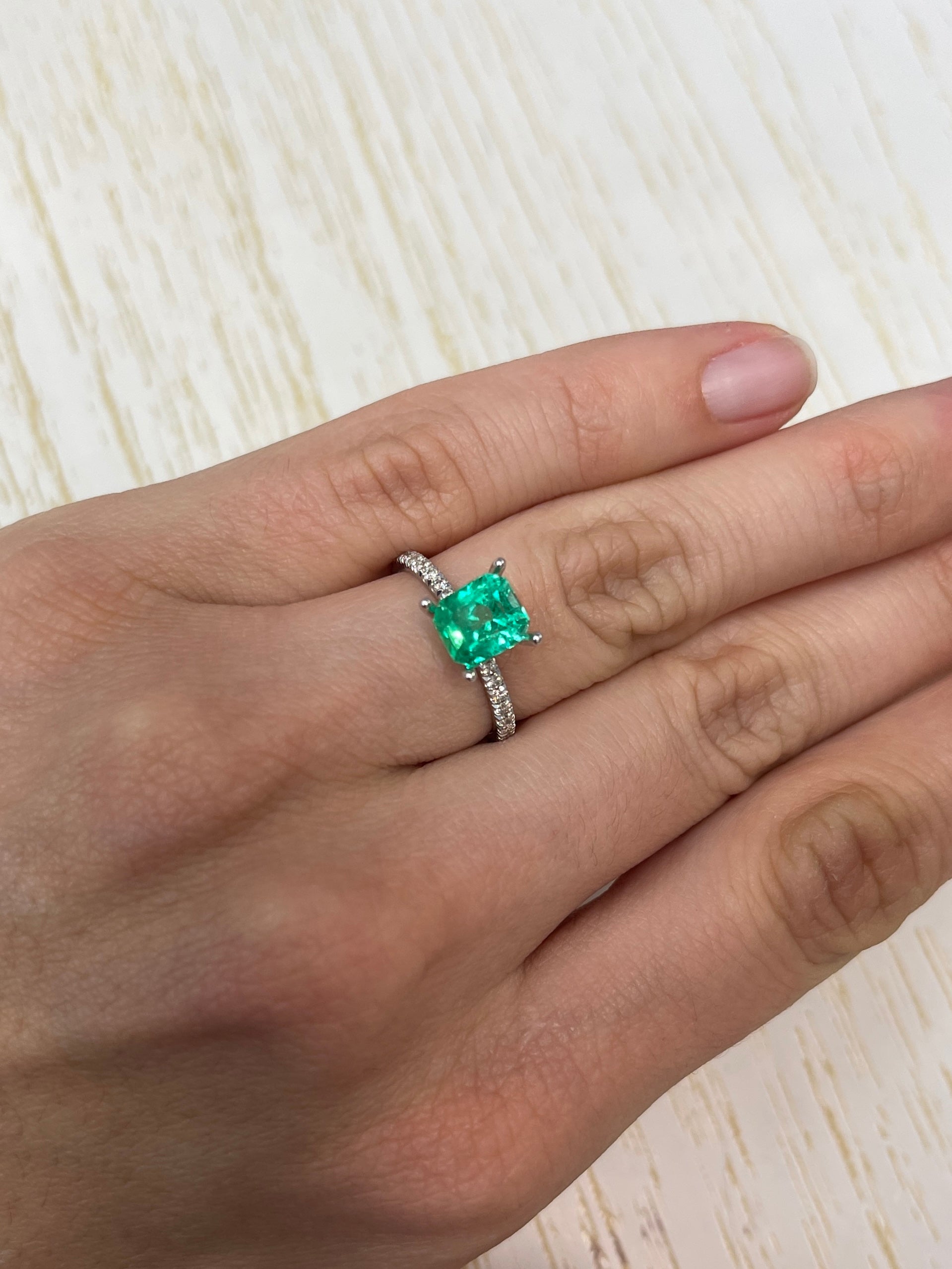 Vivid green 1.96 carat natural Colombian emerald loose gemstone in emerald cut, showcasing vibrant color and clarity.