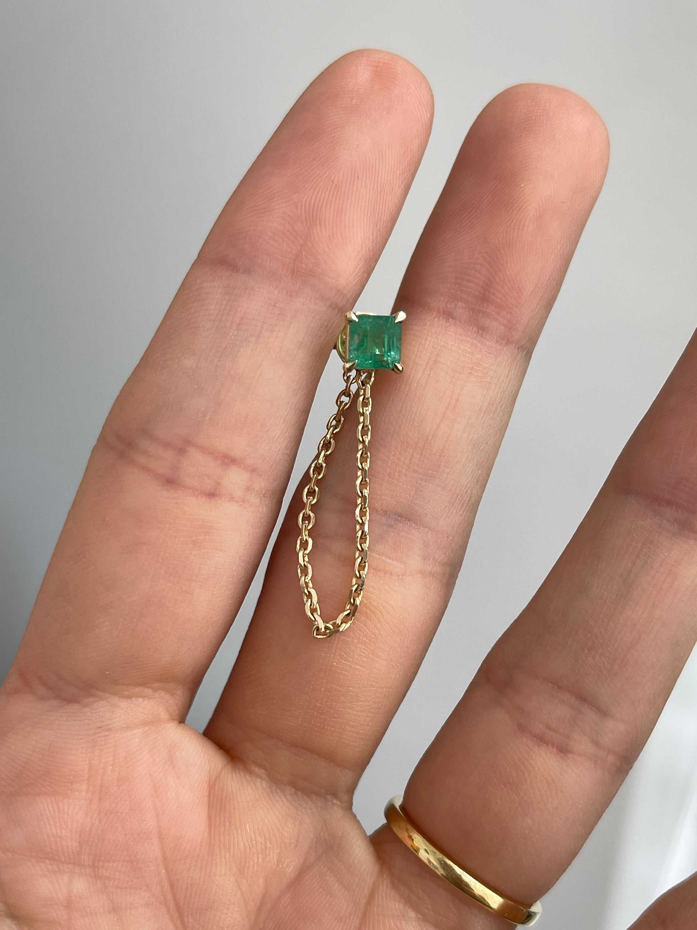 14K gold single emerald stud earring with asscher cut and delicate chain detail
