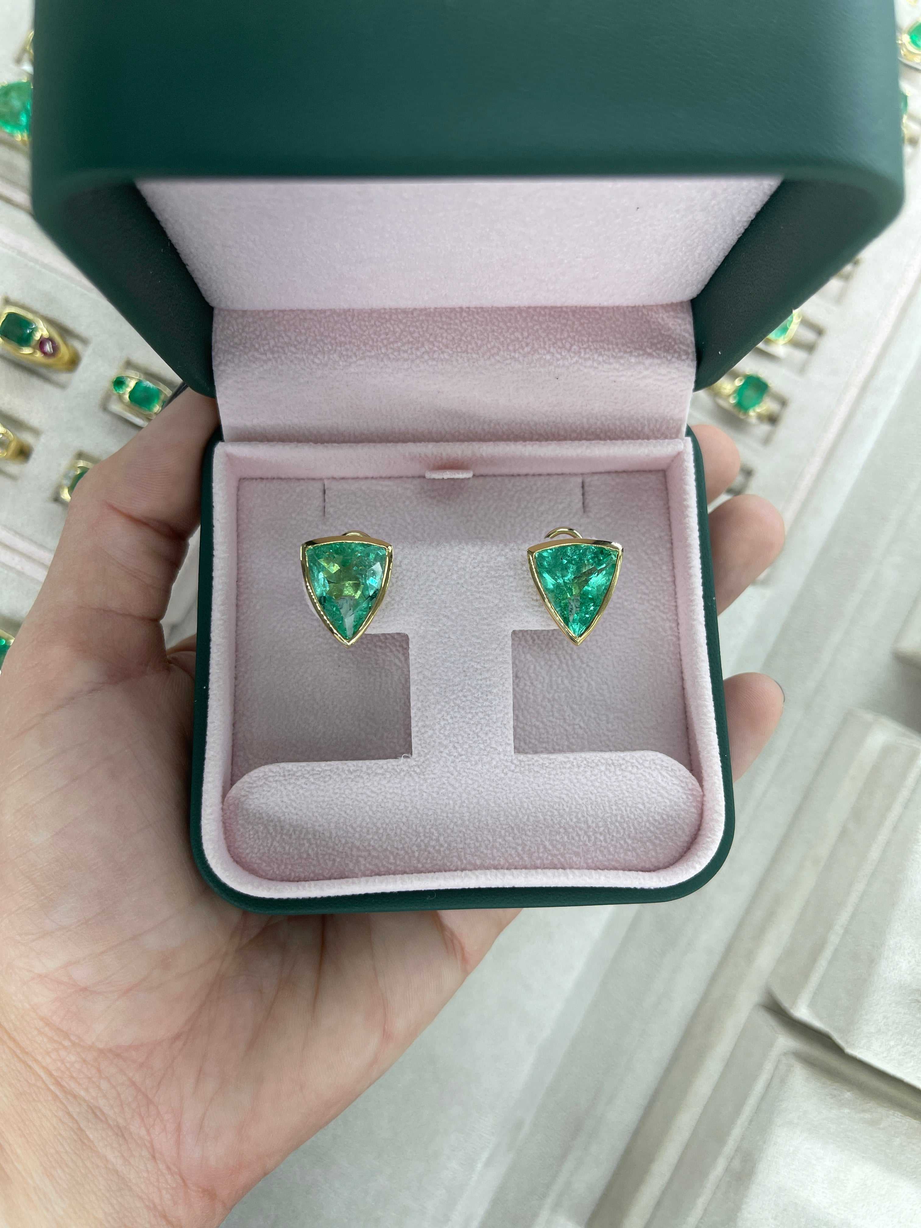 15.76tcw rare large trillion cut Colombian emerald bezel set omega earrings in 18K gold in green jewelry box