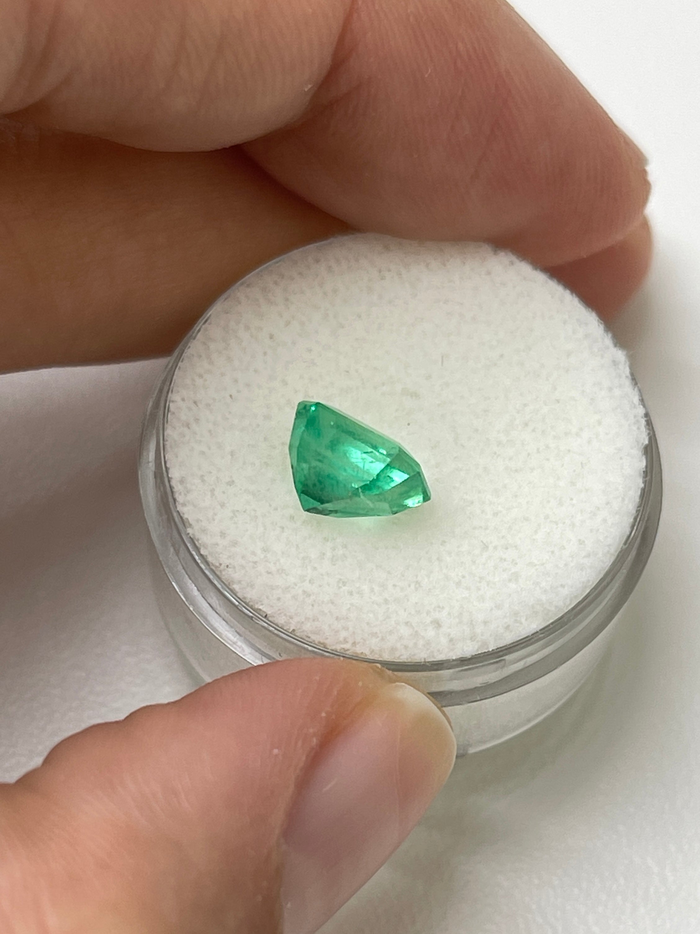 2.08 Carat lime yellowish emerald cut natural Colombian emerald unset, showcasing vibrant color and clarity in a close-up image.