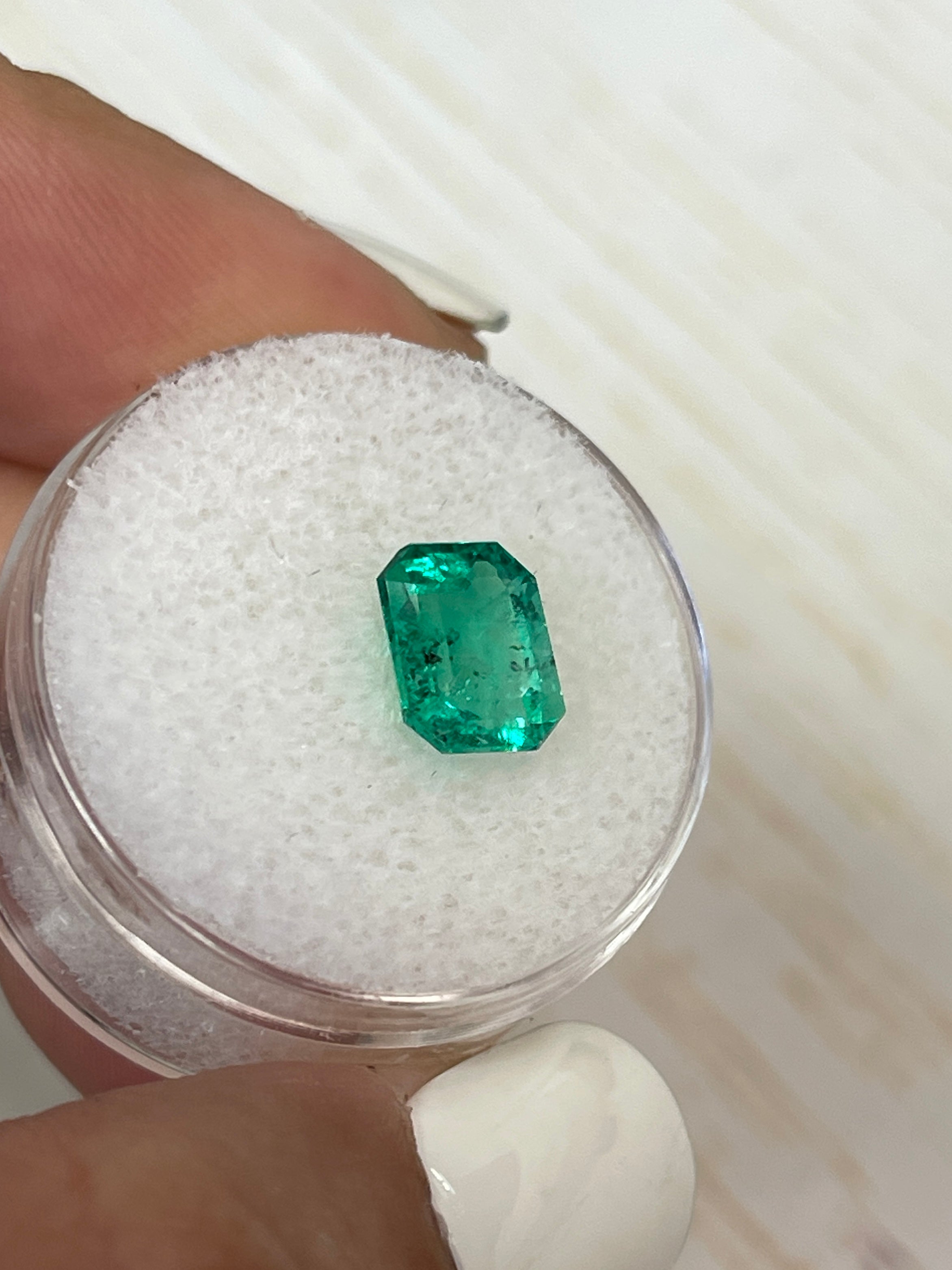 2.12 carat bluish green Colombian emerald loose gemstone with natural freckles, emerald cut, from JR Colombian Emeralds.