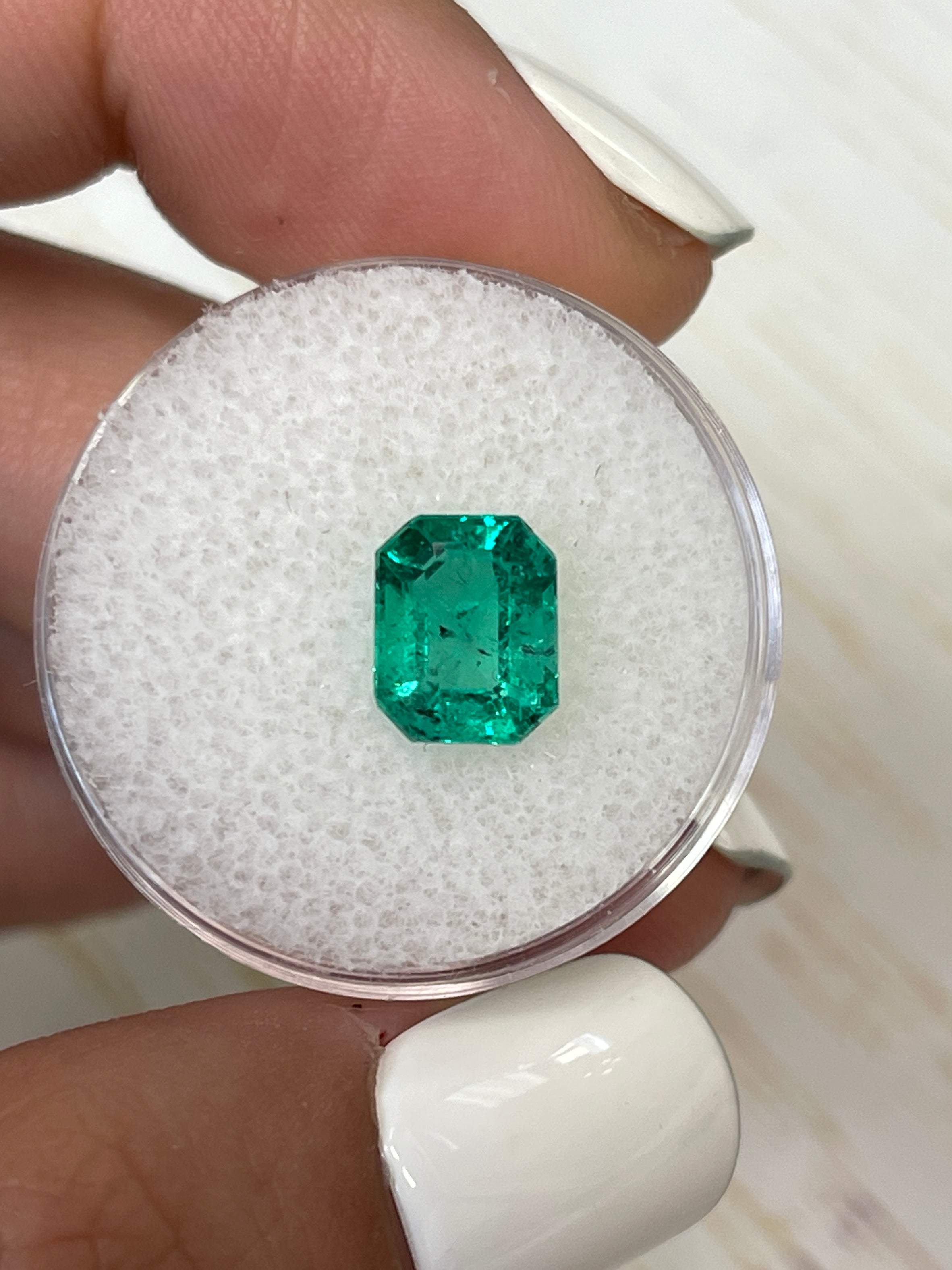 2.12 Carat freckled bluish-green Colombian emerald in an emerald cut, natural loose gemstone from JR Colombian Emeralds.