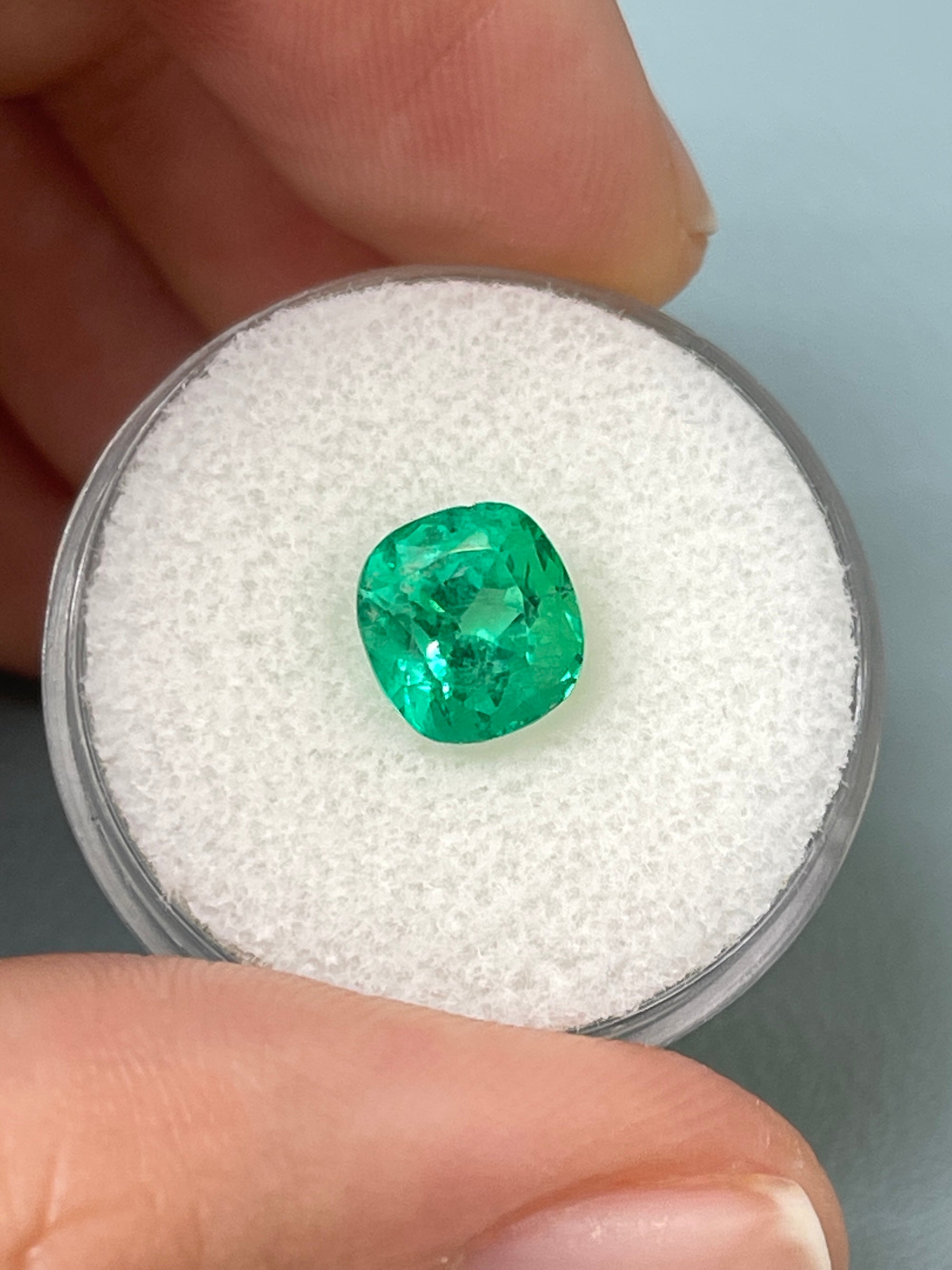 2.13 carat electric Muzo green Colombian emerald loose cushion cut gemstone with natural clarity and vibrant color.