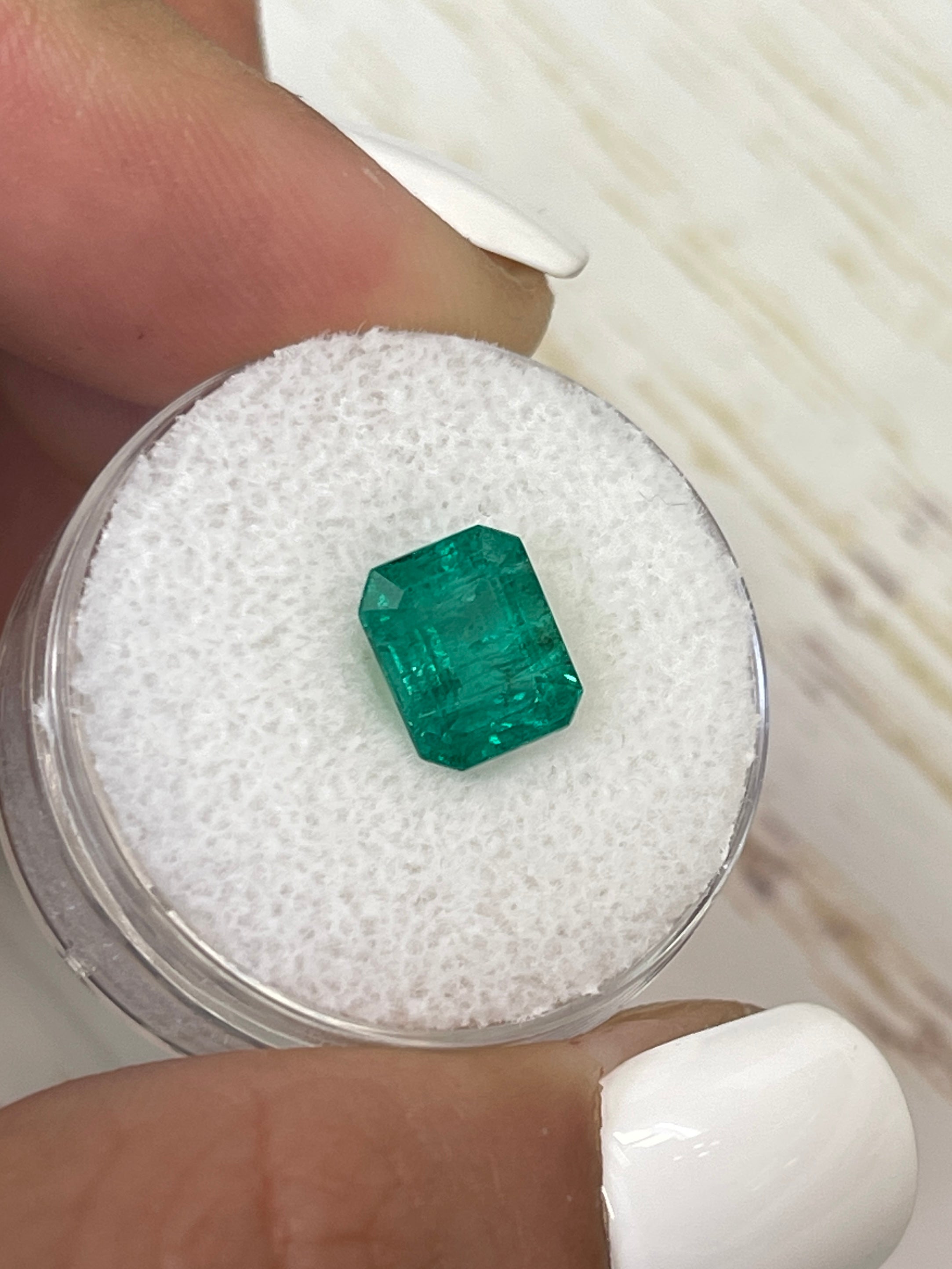 Medium green 2.26 carat natural Zambian emerald in emerald cut, from JR Colombian Emeralds, shown as a loose gemstone.