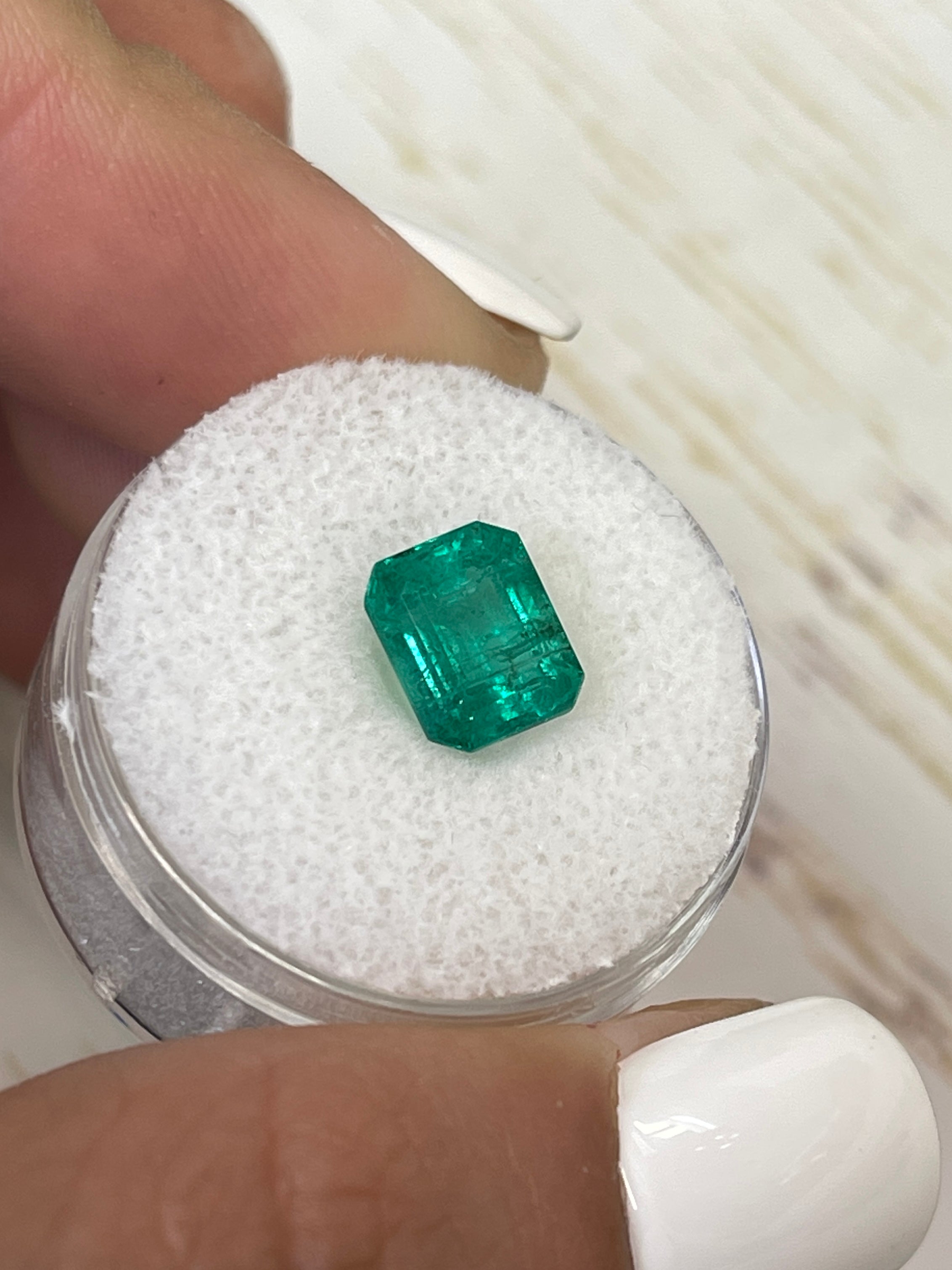 Medium green 2.26 carat natural Zambian emerald in emerald cut, showcasing its vibrant color and clarity.