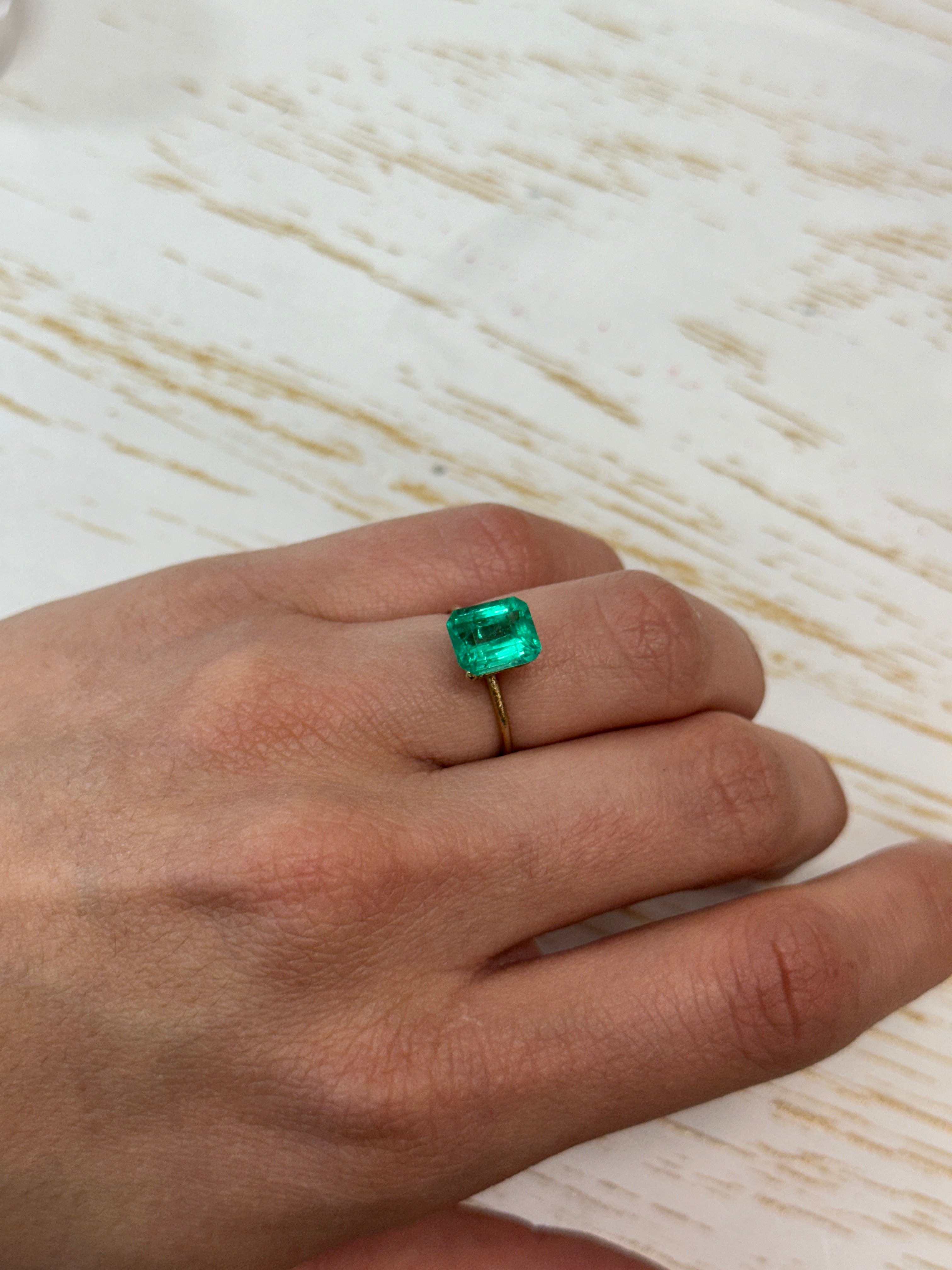 2.27 Carat Muzo medium green natural Colombian emerald loose gemstone with emerald cut, showcasing vibrant green color and clarity.