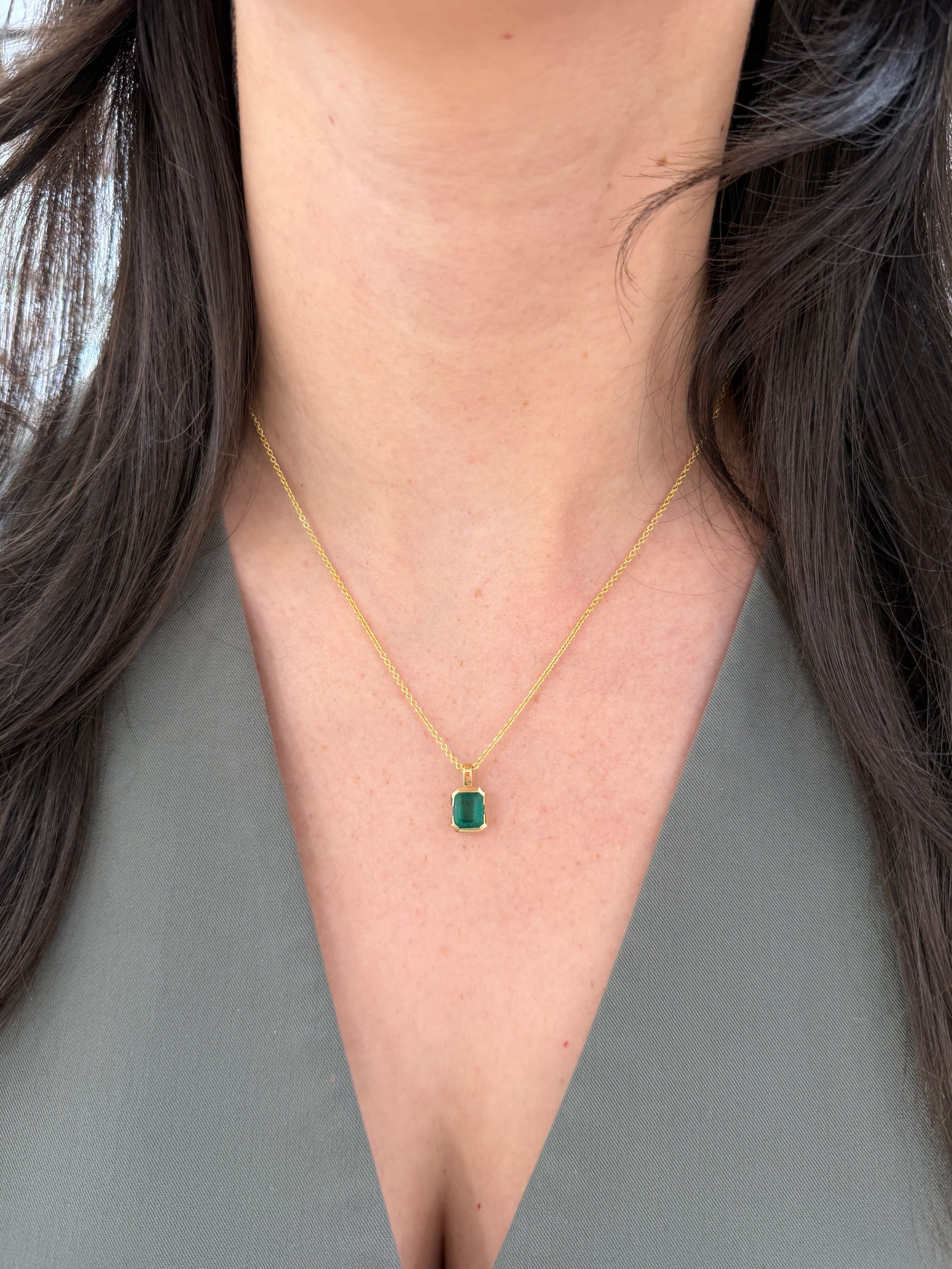 2.28 carat semi-bezel emerald solitaire necklace by JR Colombian Emeralds with 14K gold, touching the skin with vibrant green emerald.
