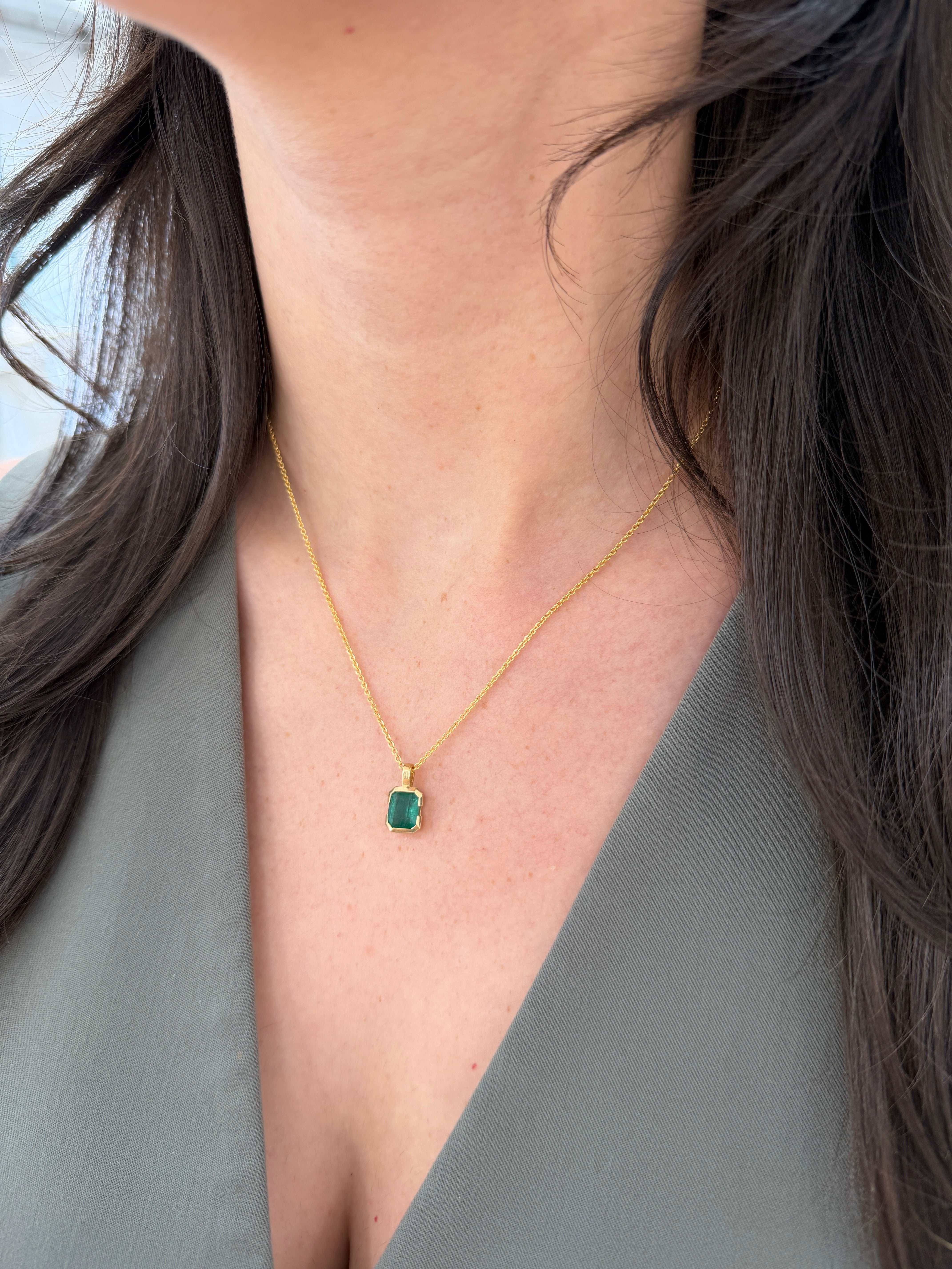 22.8 Carat semi-bezel emerald solitaire necklace in 14K gold by JR Colombian Emeralds, featuring a vibrant emerald centerpiece.