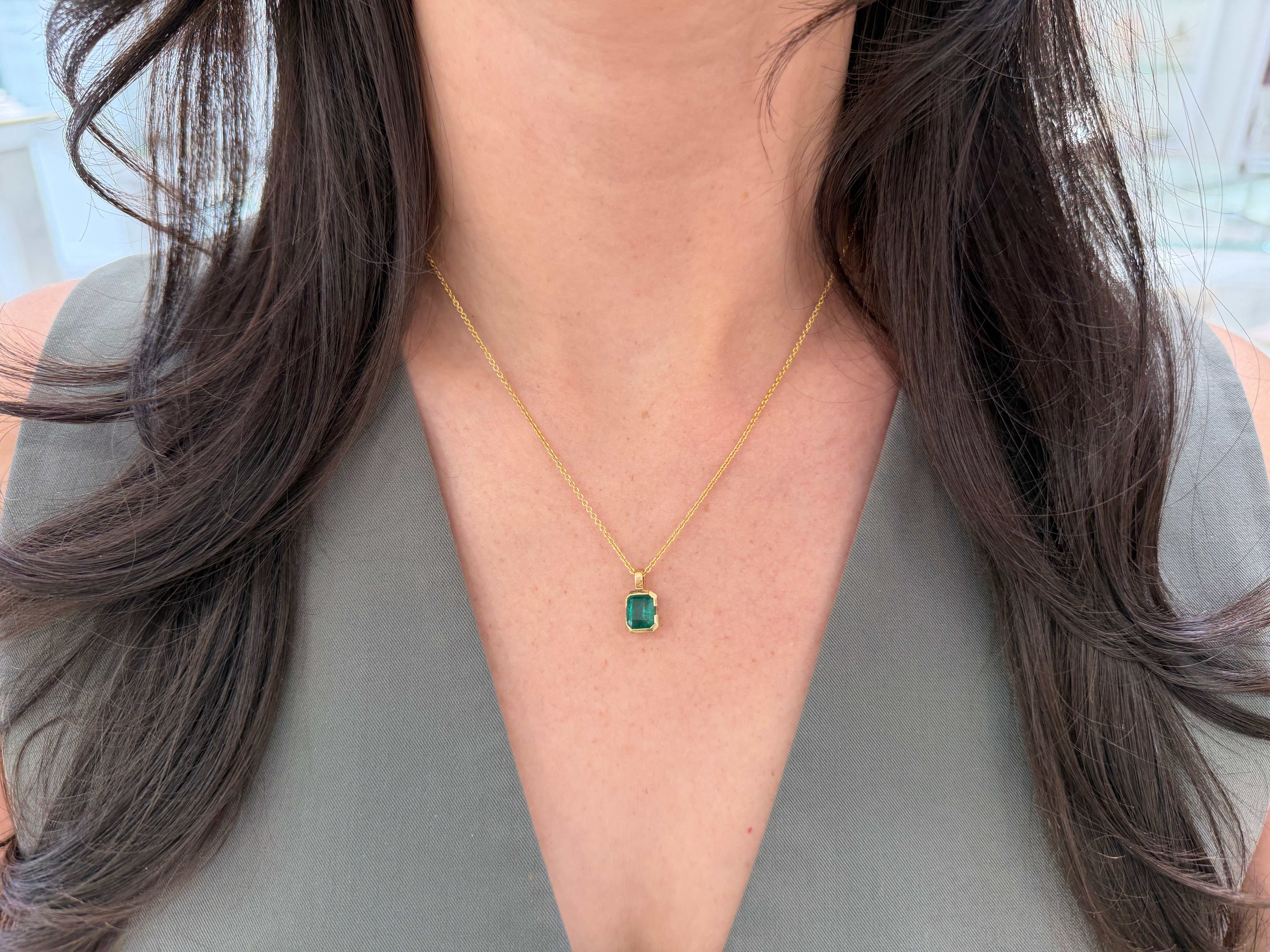 14K gold emerald solitaire necklace featuring a 2.28 carat semi-bezel emerald pendant, designed to touch the skin, by JR Colombian Emeralds.