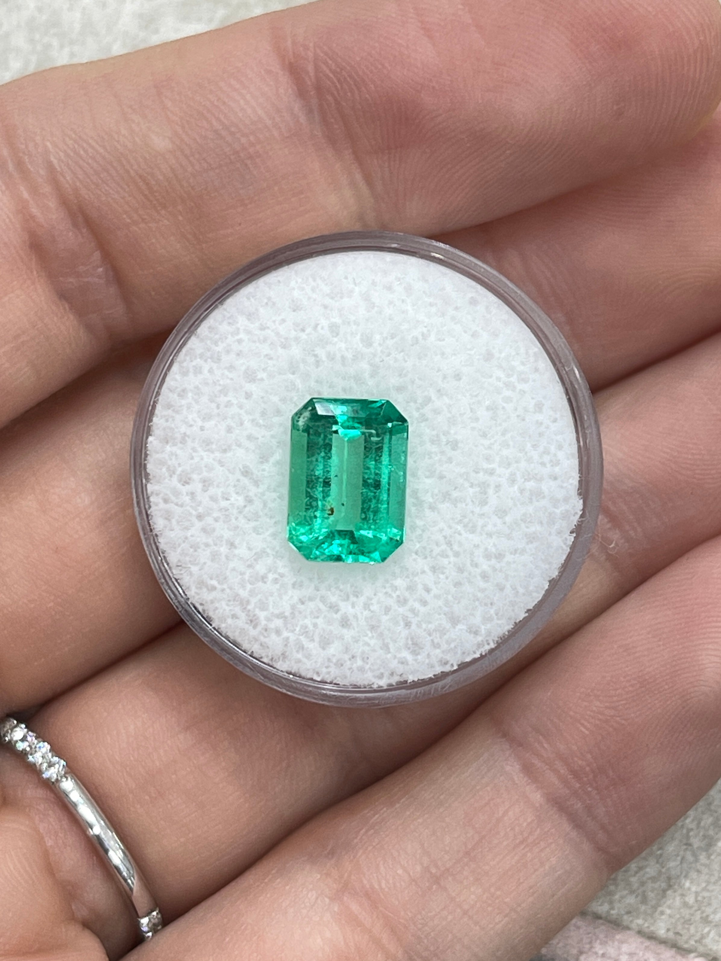 Medium green Colombian emerald cut gemstone with natural freckles, 2.31 carats, from JR Colombian Emeralds.