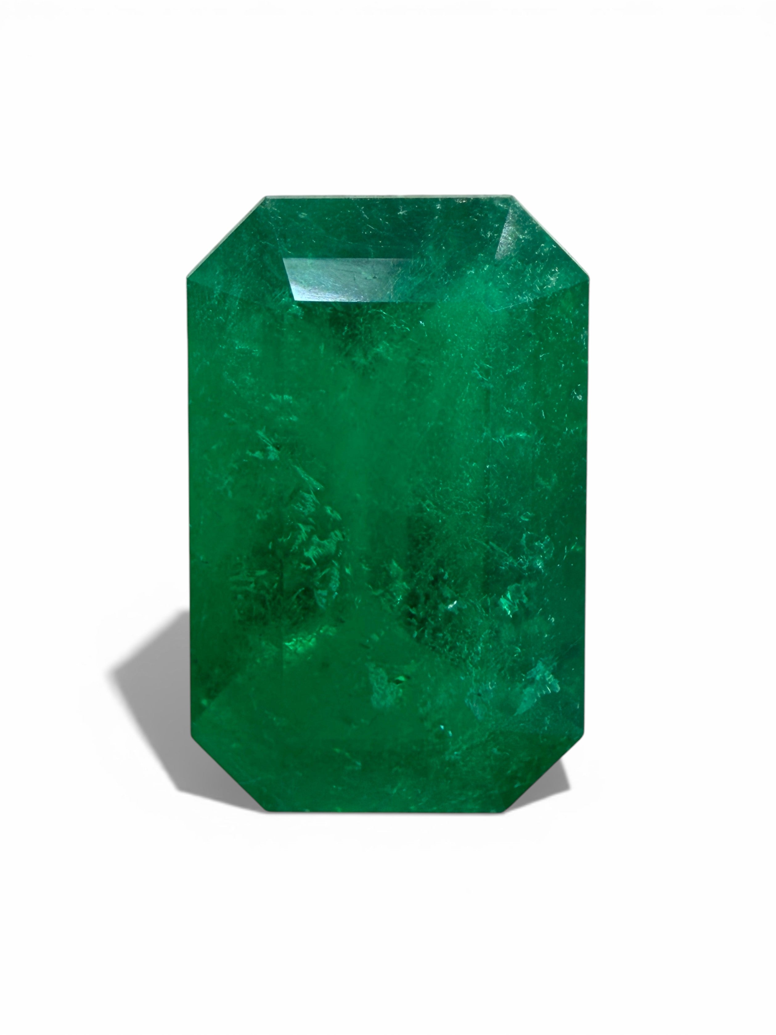 Deep jungle green 2.40 carat natural Colombian emerald in elongated emerald cut, displayed as a loose gemstone.