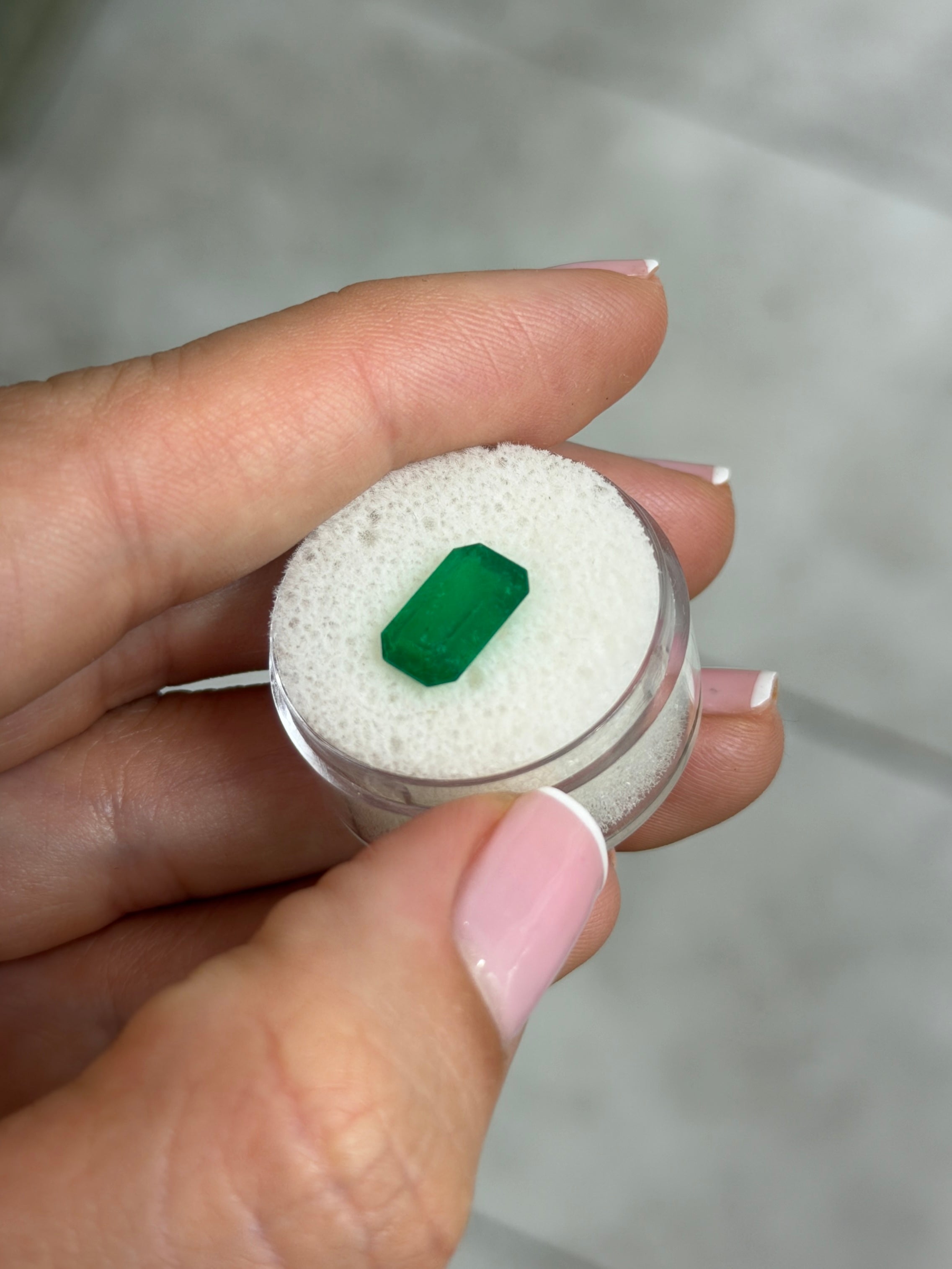 Deep jungle green 2.40 carat natural Colombian emerald in elongated cut, showcasing vibrant color and clarity.