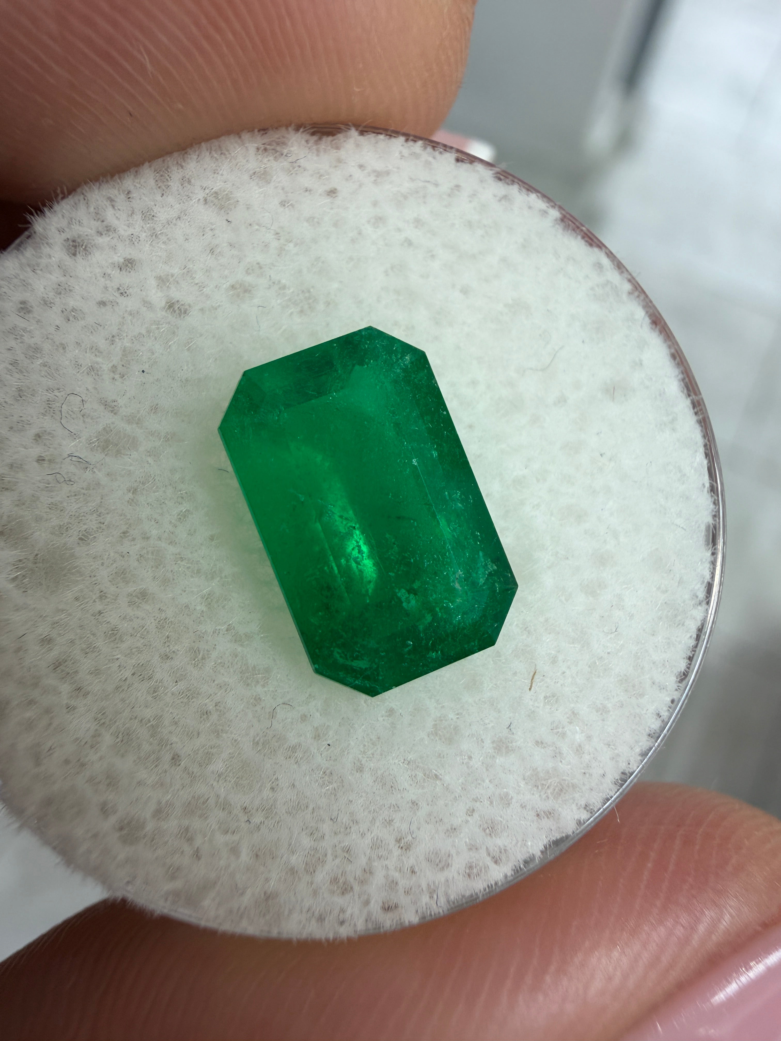 Deep jungle green 2.40 carat natural Colombian emerald in elongated emerald cut, from JR Colombian Emeralds.