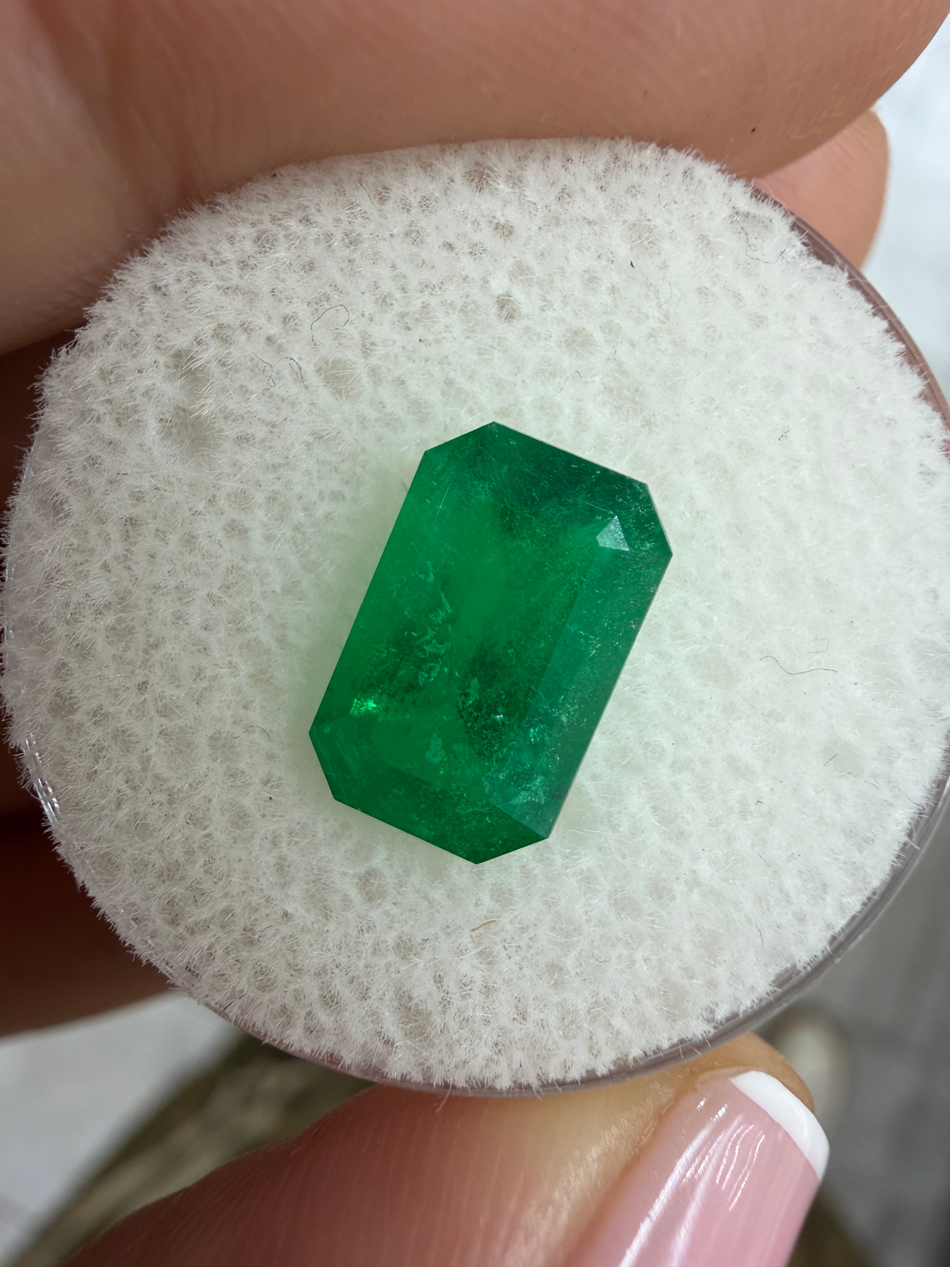 Deep jungle green 2.40 carat Colombian loose emerald with elongated emerald cut, natural and vibrant, from JR Colombian Emeralds.
