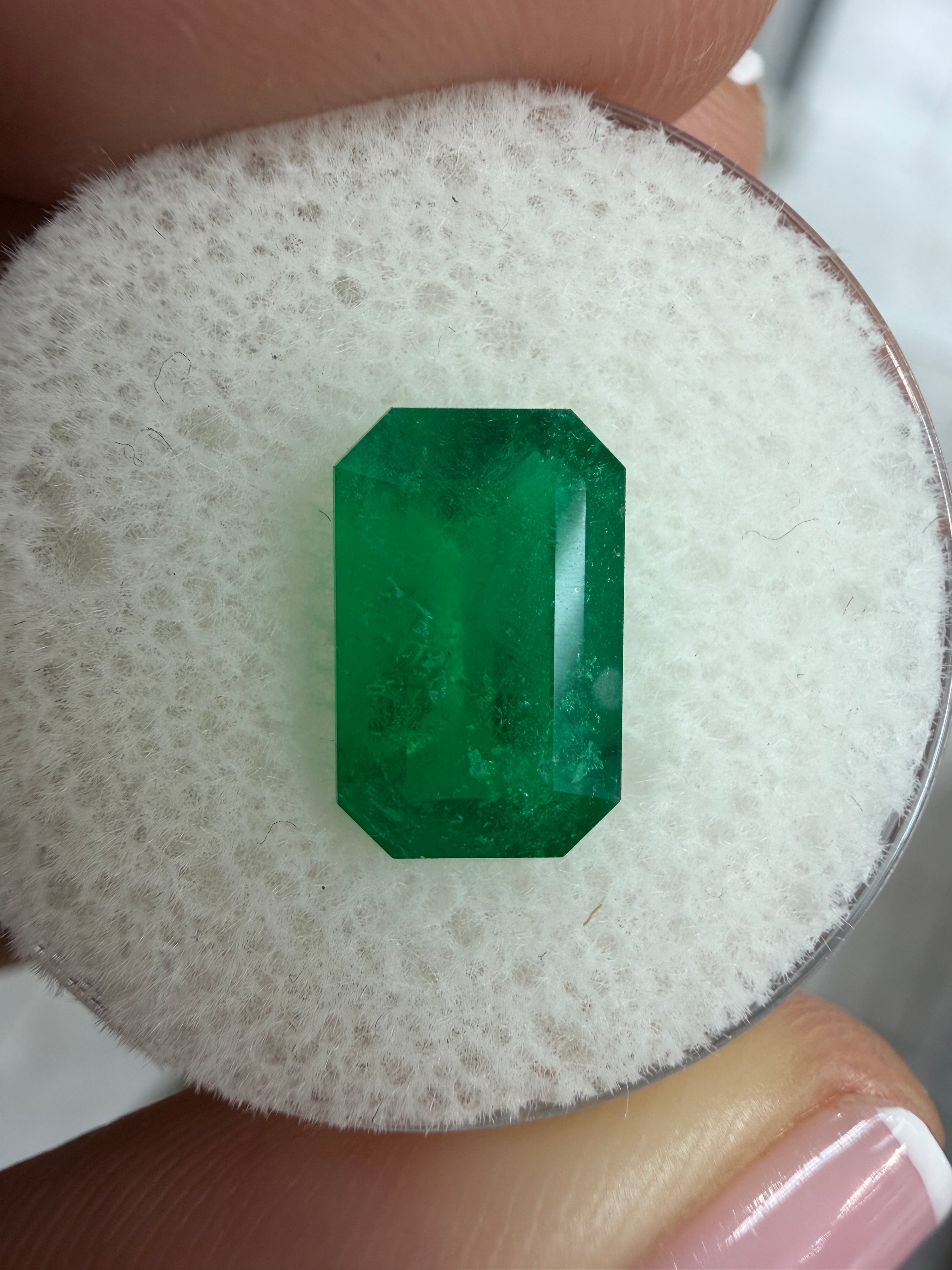 Deep jungle green 2.40 carat elongated Colombian emerald in emerald cut, natural loose gemstone by JR Colombian Emeralds.