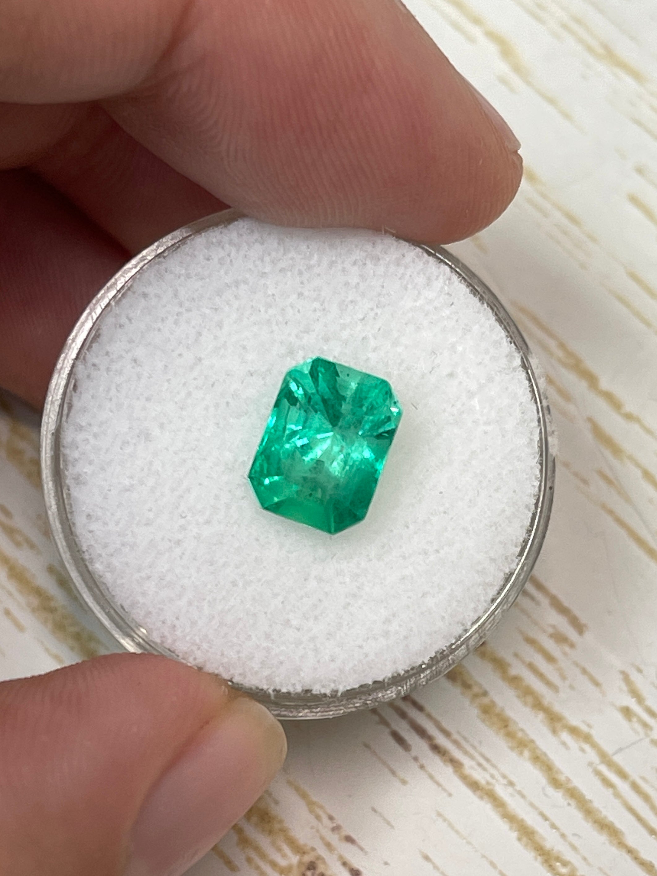 Natural 2.44 carat 9x7 spring green Colombian emerald loose gemstone in emerald cut, showcasing vibrant color and clarity.
