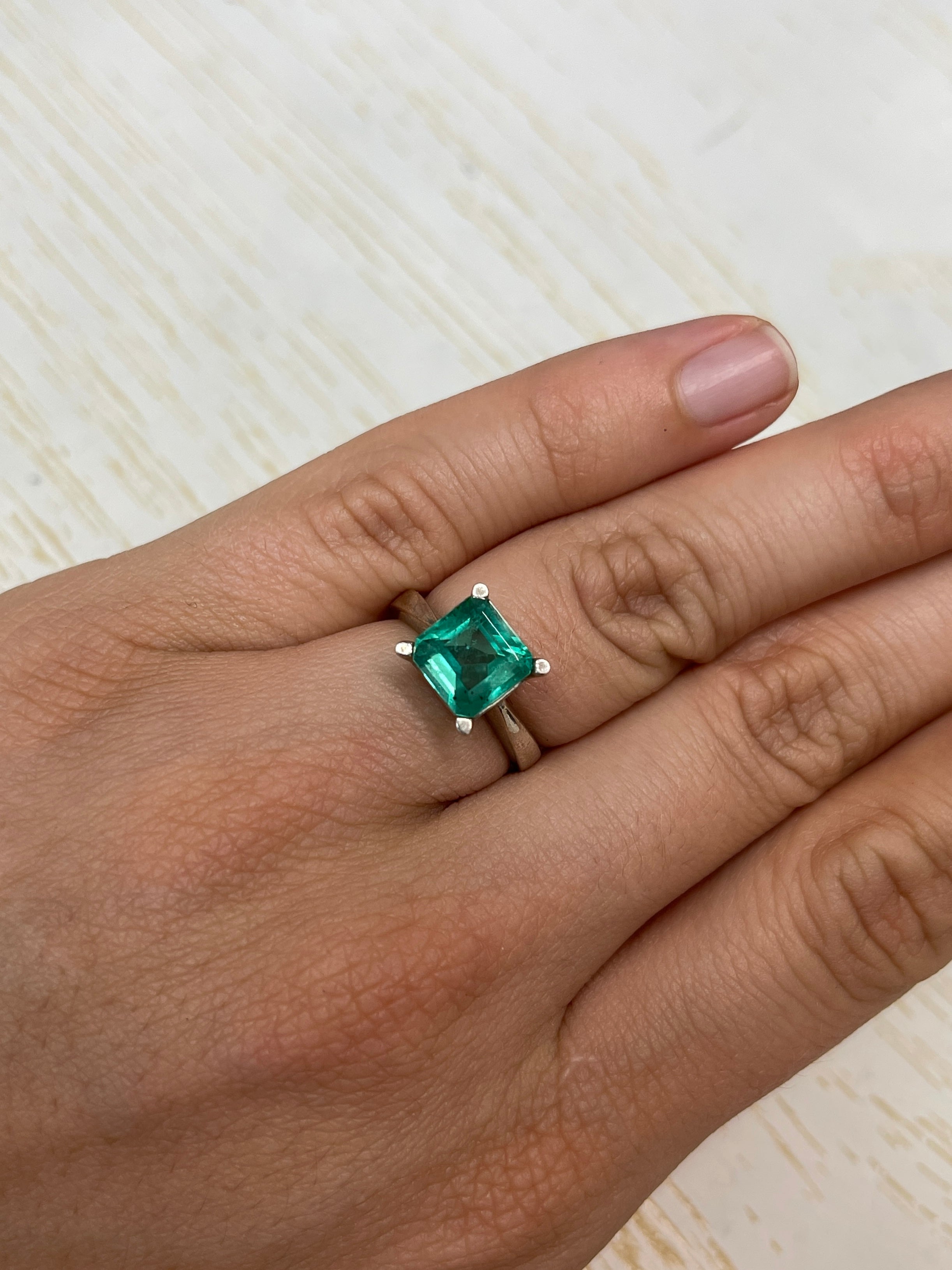 Bluish green 2.44 carat Colombian emerald loose gemstone in Asscher cut with natural freckles, from JR Colombian Emeralds.