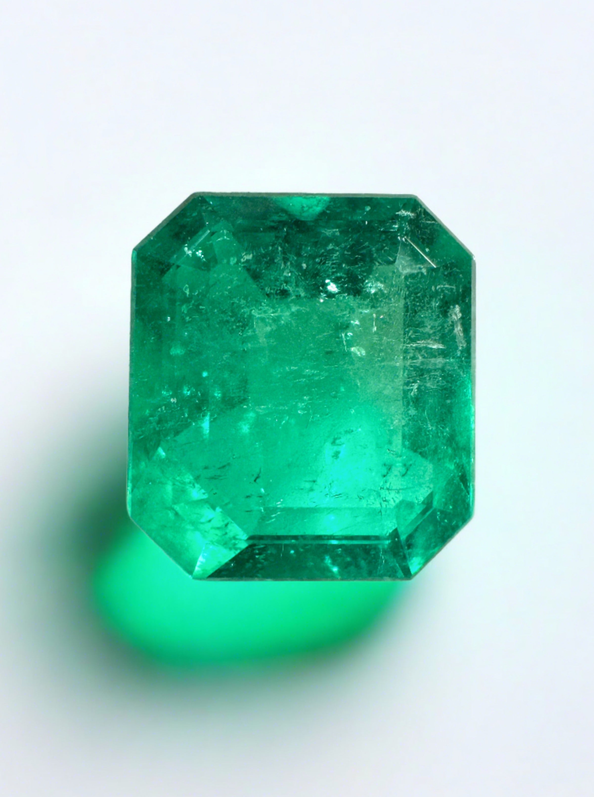 Deep bluish 2.63 carat natural Colombian emerald in an emerald cut, showcasing its vibrant color and clarity.