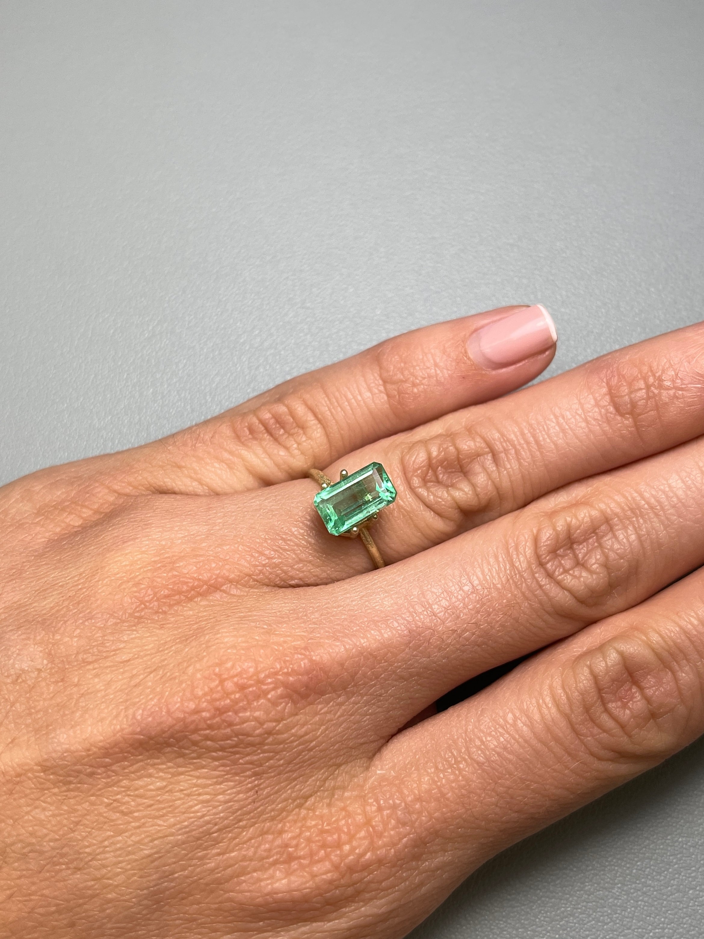 2.64 carat emerald cut Colombian emerald with pastel yellowish-green color, loose gemstone from JR Colombian Emeralds.
