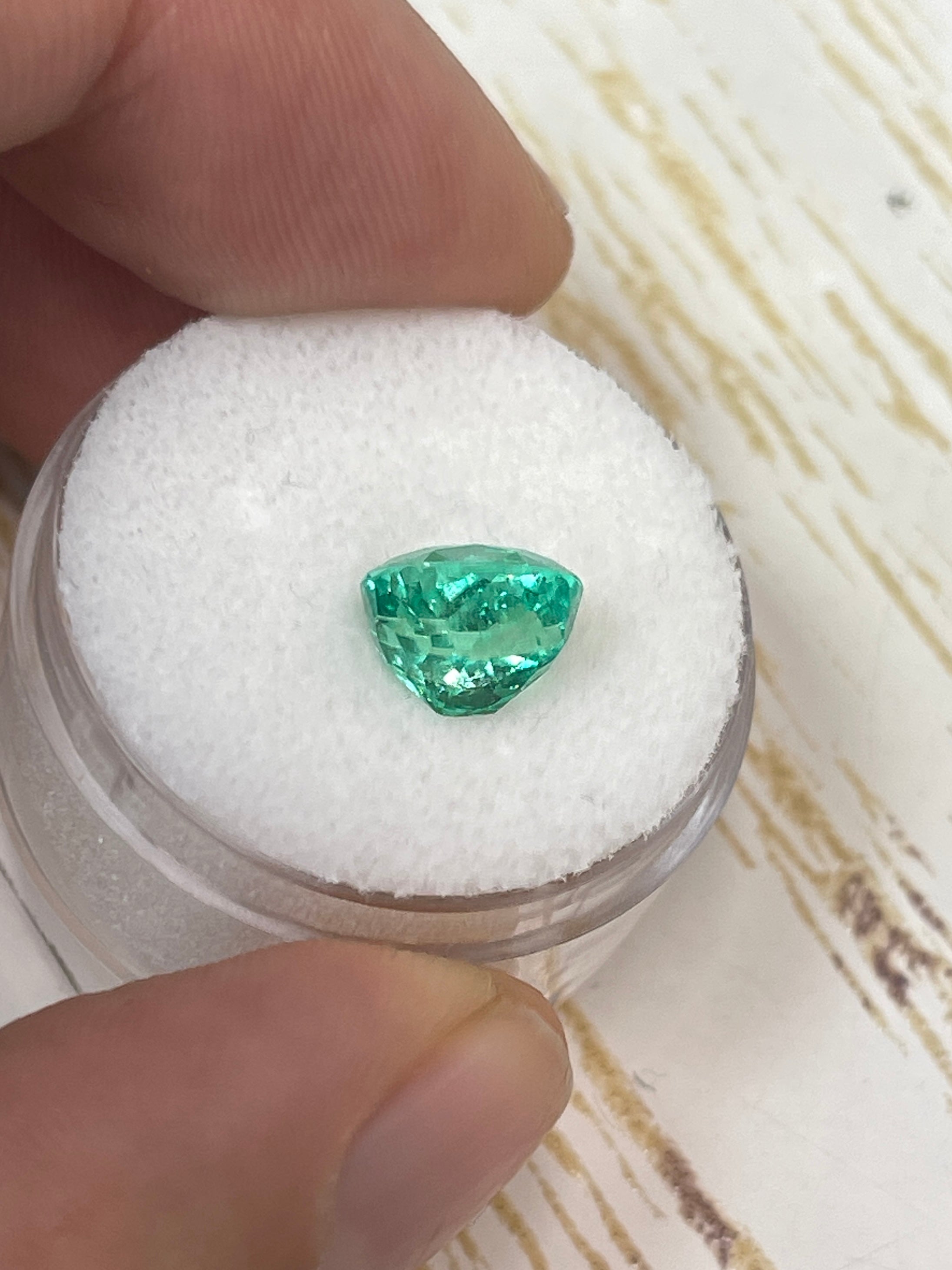 Bright 2.67 carat Muzo green Colombian emerald cushion cut, natural loose gemstone with glowing, vibrant green color.