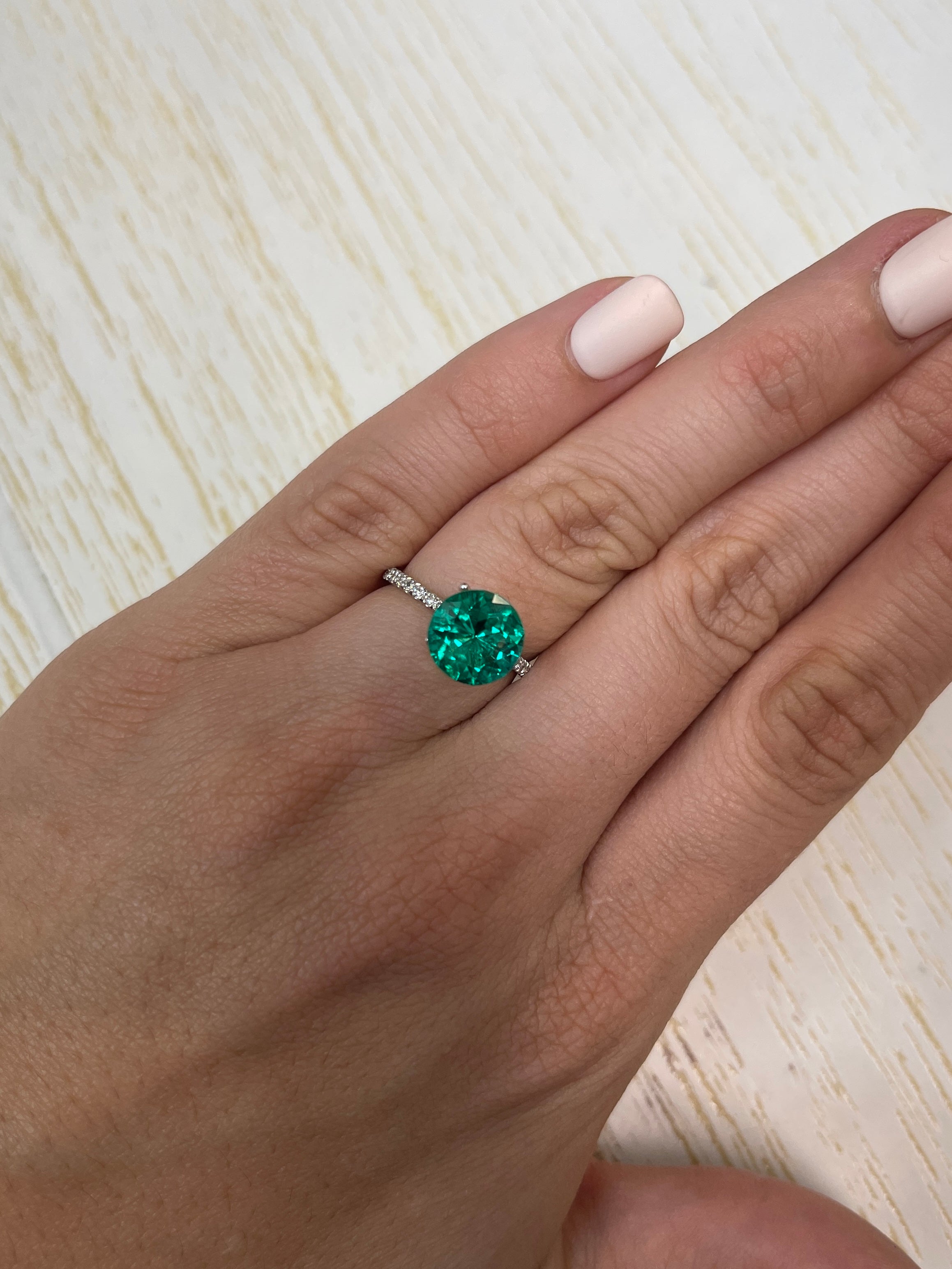 2.71 carat round Colombian emerald with AAA+ clarity, featuring a drop of oil appearance, natural loose gemstone from JR Colombian Emeralds