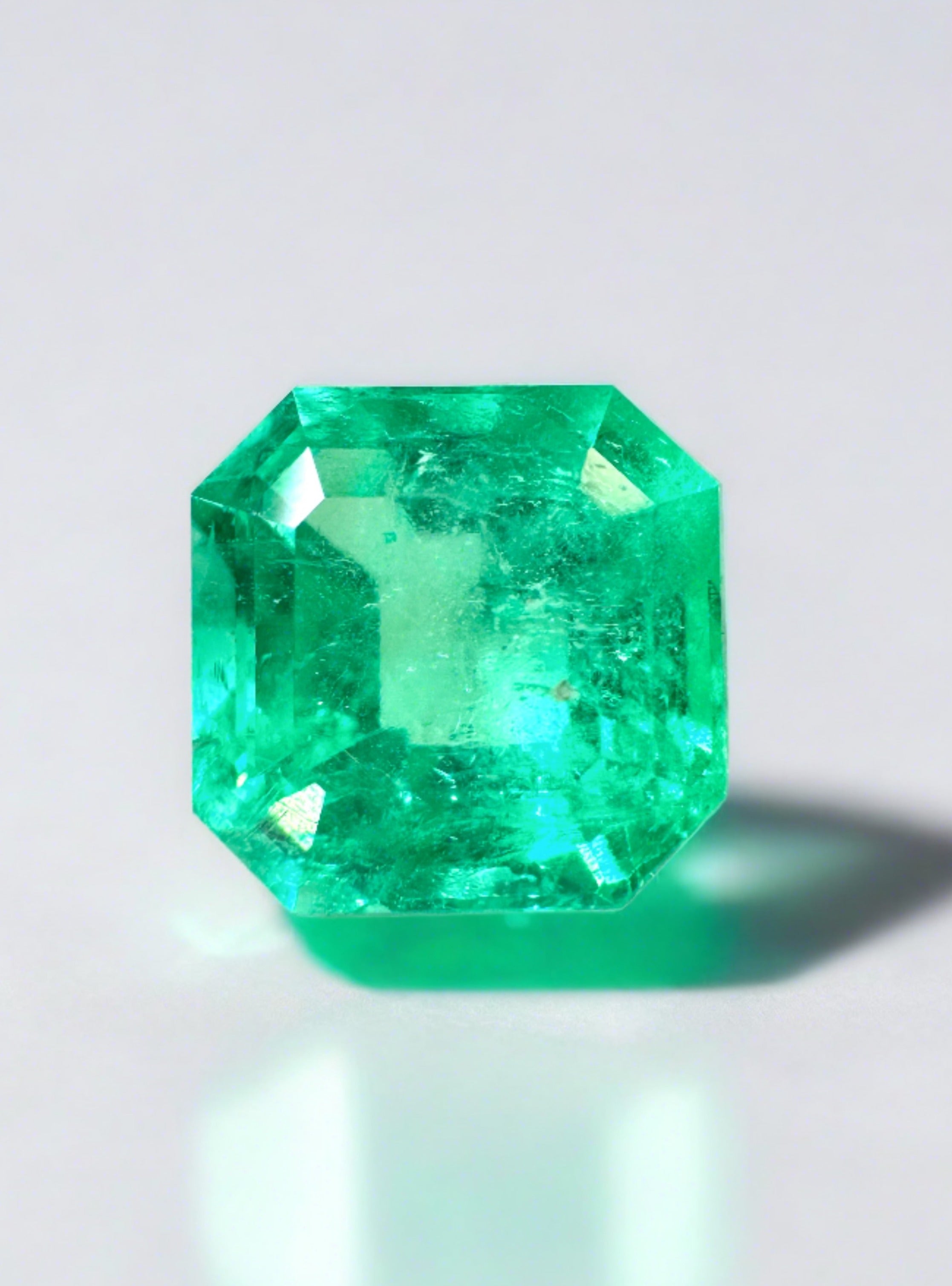 2.71 Carat electric yellowish green natural Colombian emerald loose gemstone in Asscher cut, showcased by JR Colombian Emeralds.