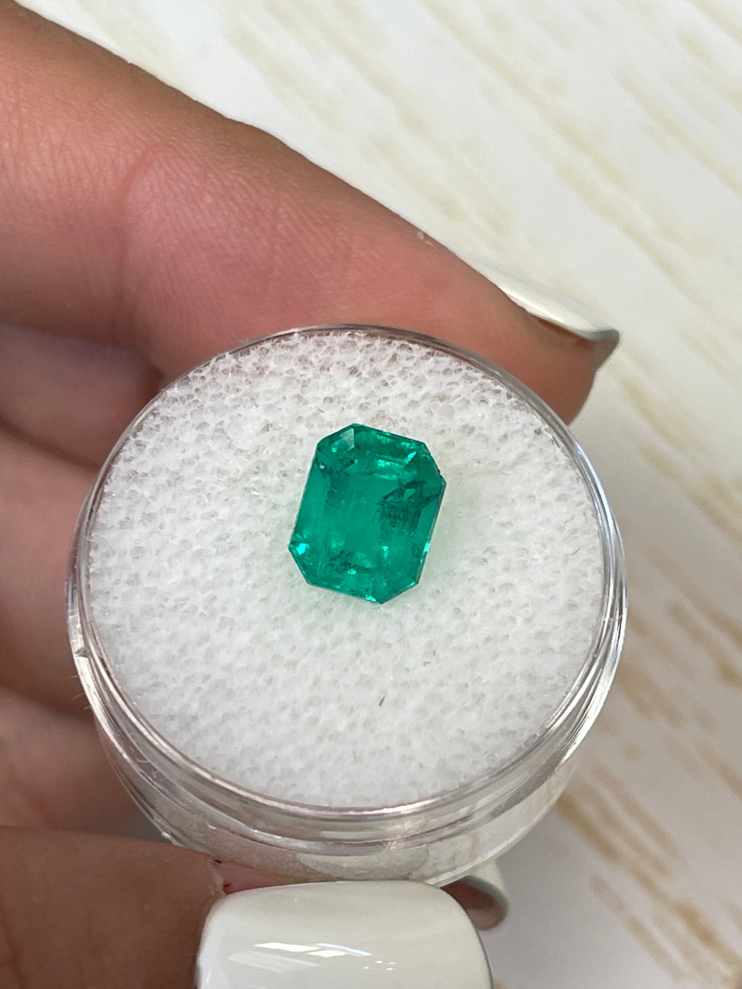 2.73 carat natural Colombian emerald loose in 9x7 emerald cut, showcasing fine bluish-green color and clarity.