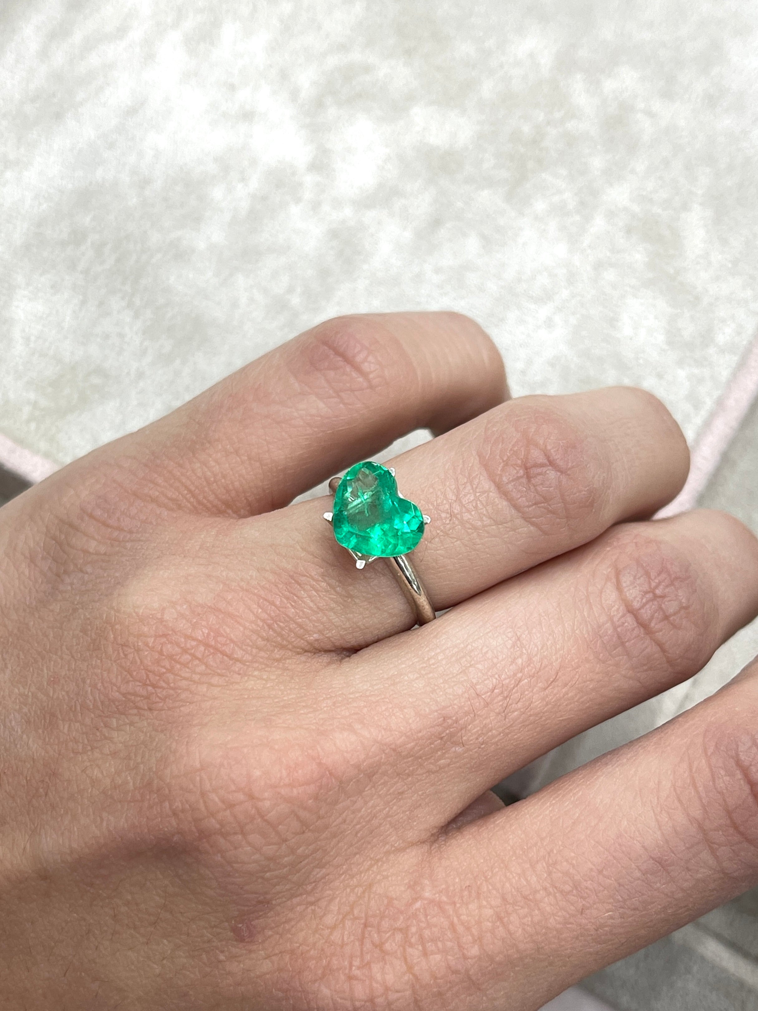 Bright medium green 2.76 carat natural Colombian emerald in heart cut, showcasing its vibrant color and clarity.