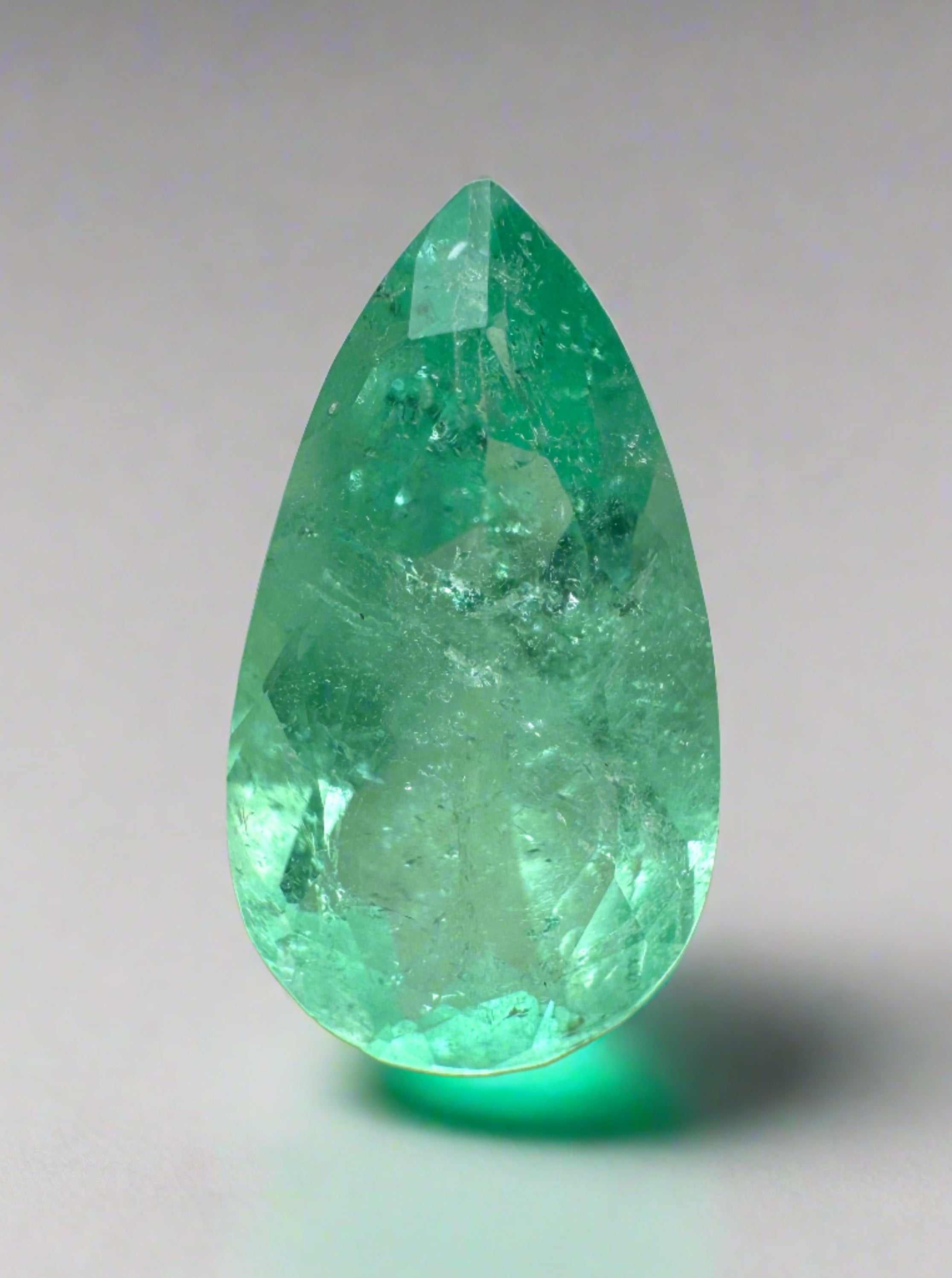 2.76 carat elongated pear cut natural Colombian emerald in vibrant green, showcasing its clarity and unique shape.